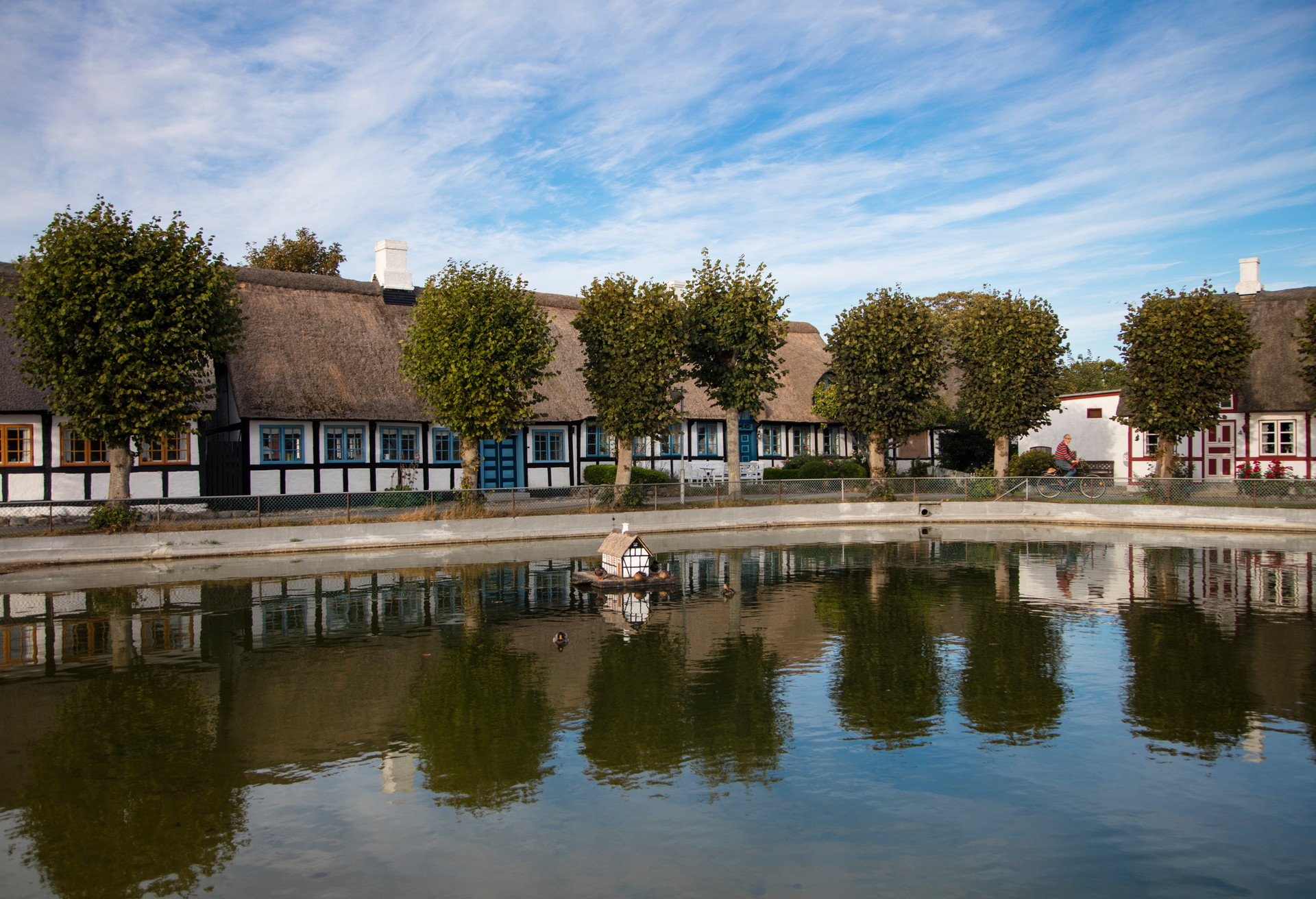 Reflection of half-timbered houses in pond, Nordby, Samsø (Samsoe), Denmark