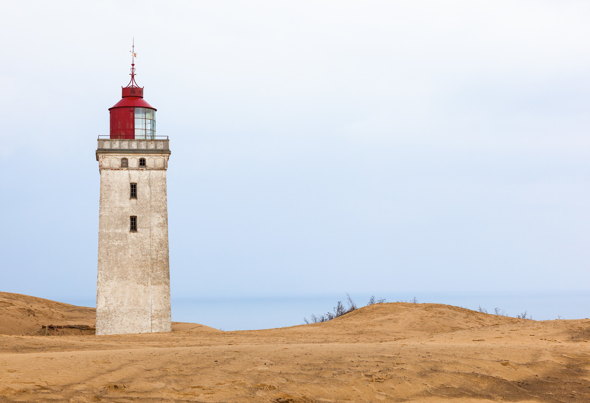 Lighthouse at Råbjerg mile in Denmark in the sand dunes