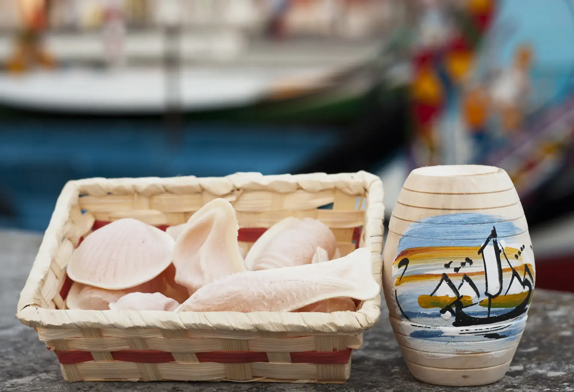 Ovos Moles d'Aveiro pastries shaped like mussels and fish in a basket