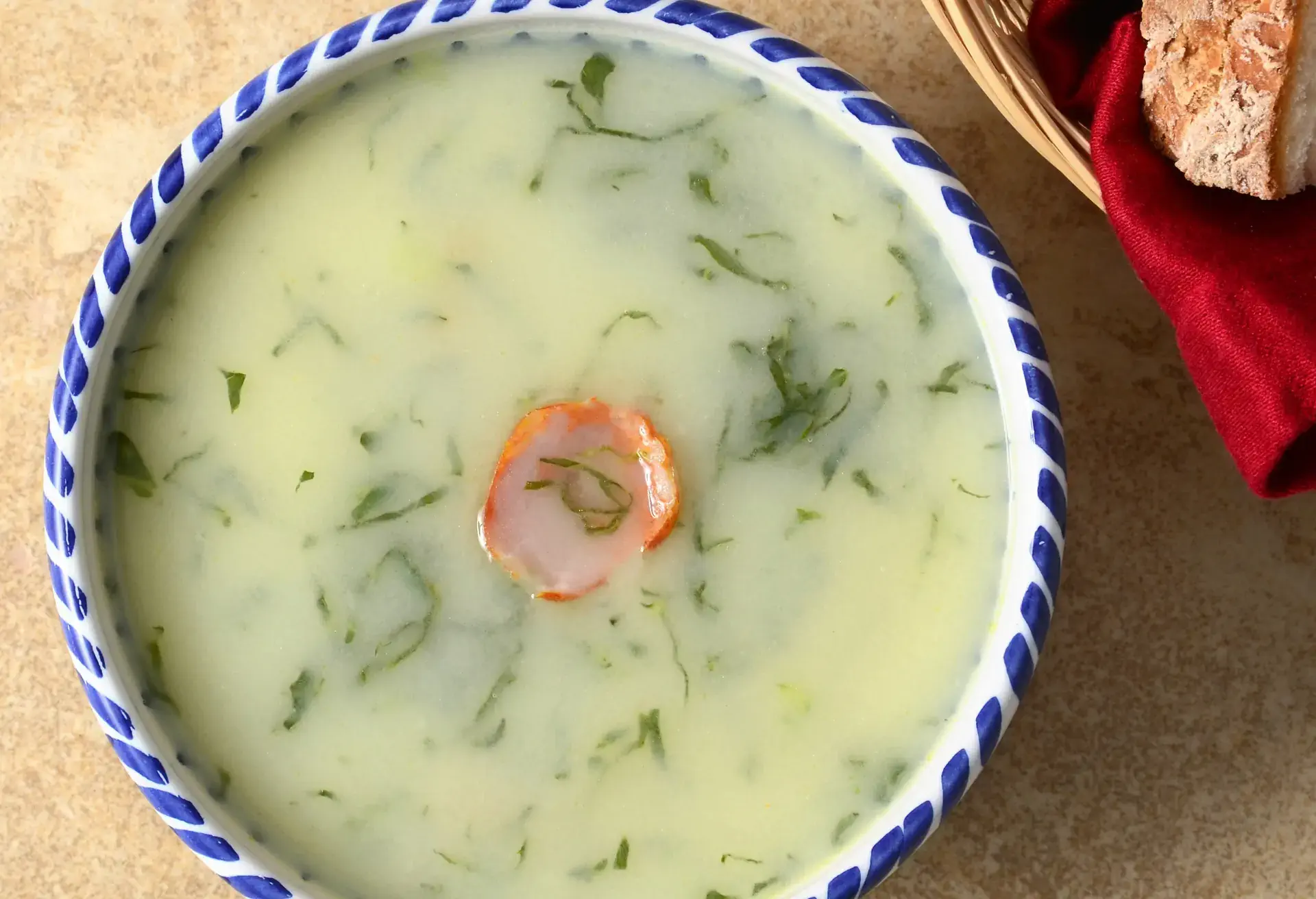 Caldo Verde soup in a blue and white bowl