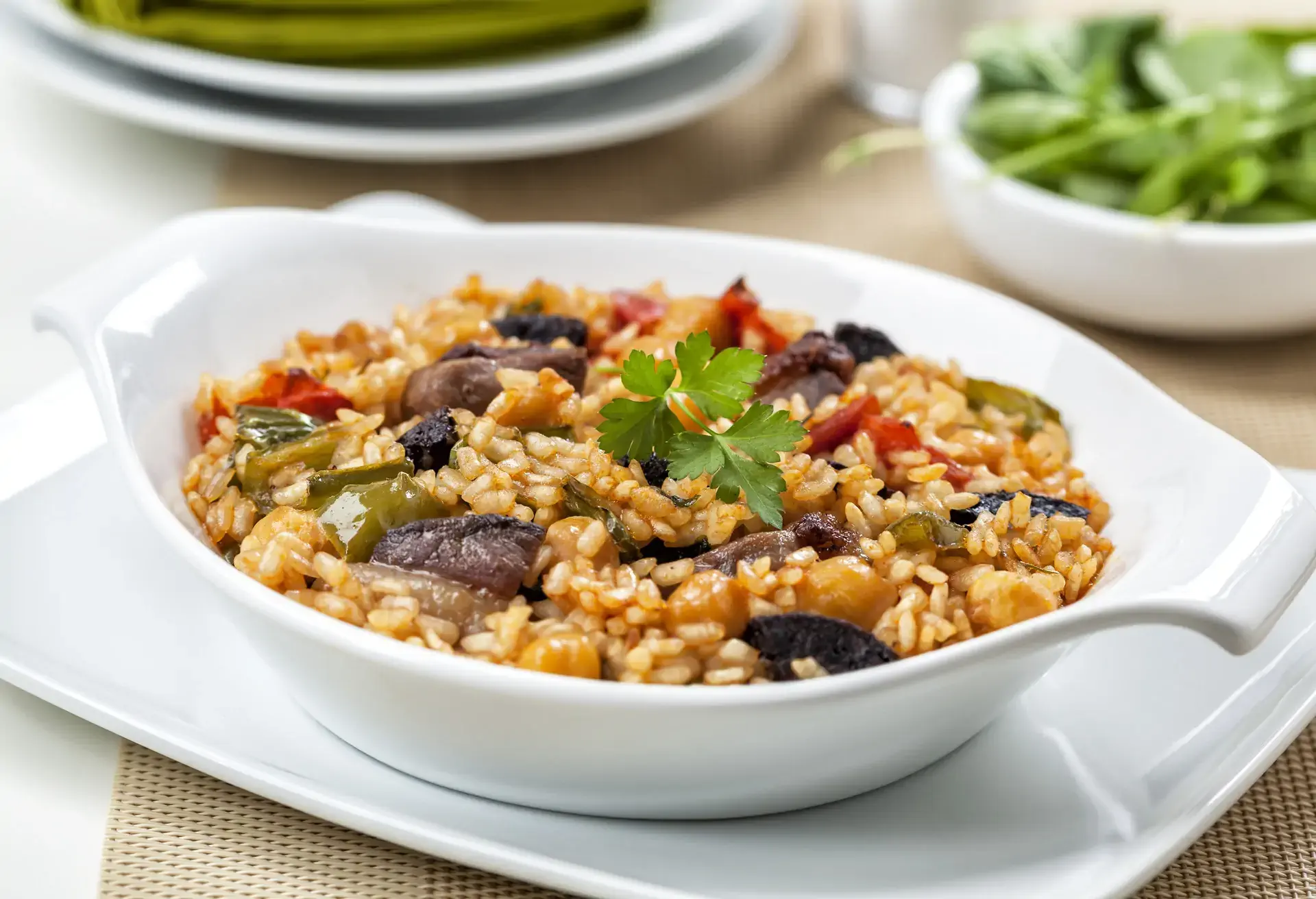 Arroz de Pato in a white dish on a white plate