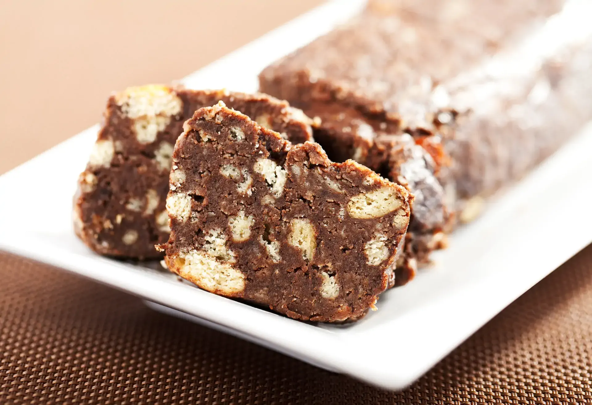 Salame de chocolate slices on a white platter