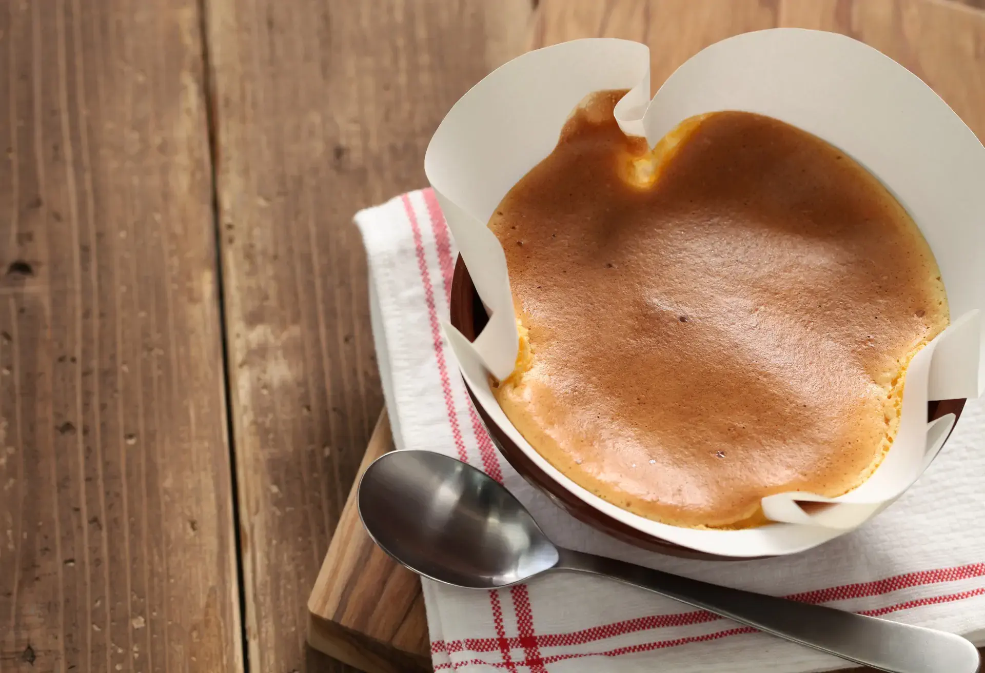 Pão de ló sponge cake in a white paper on a wooden table