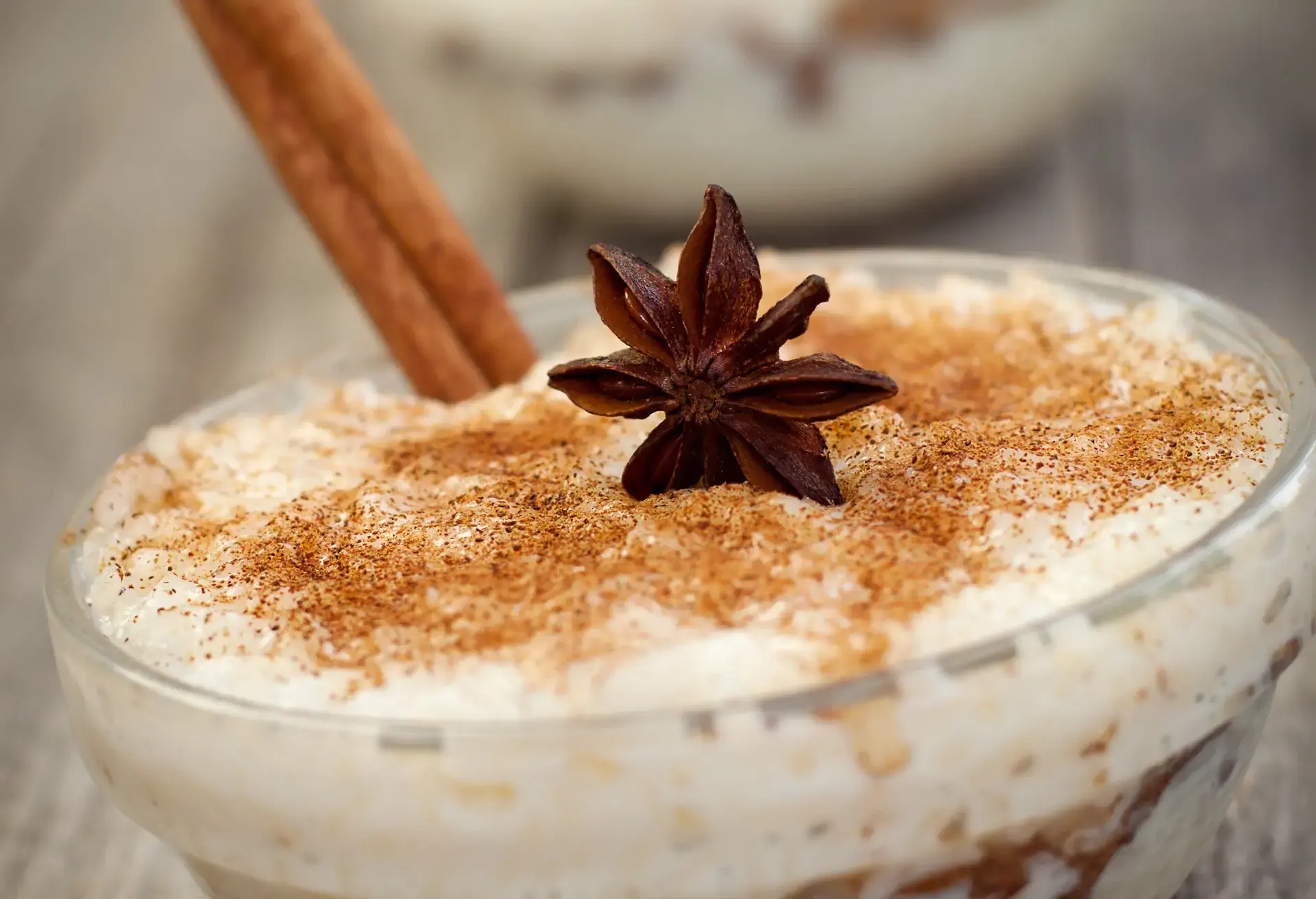 Arroz doce with cinnamon stick and star anise in a glass
