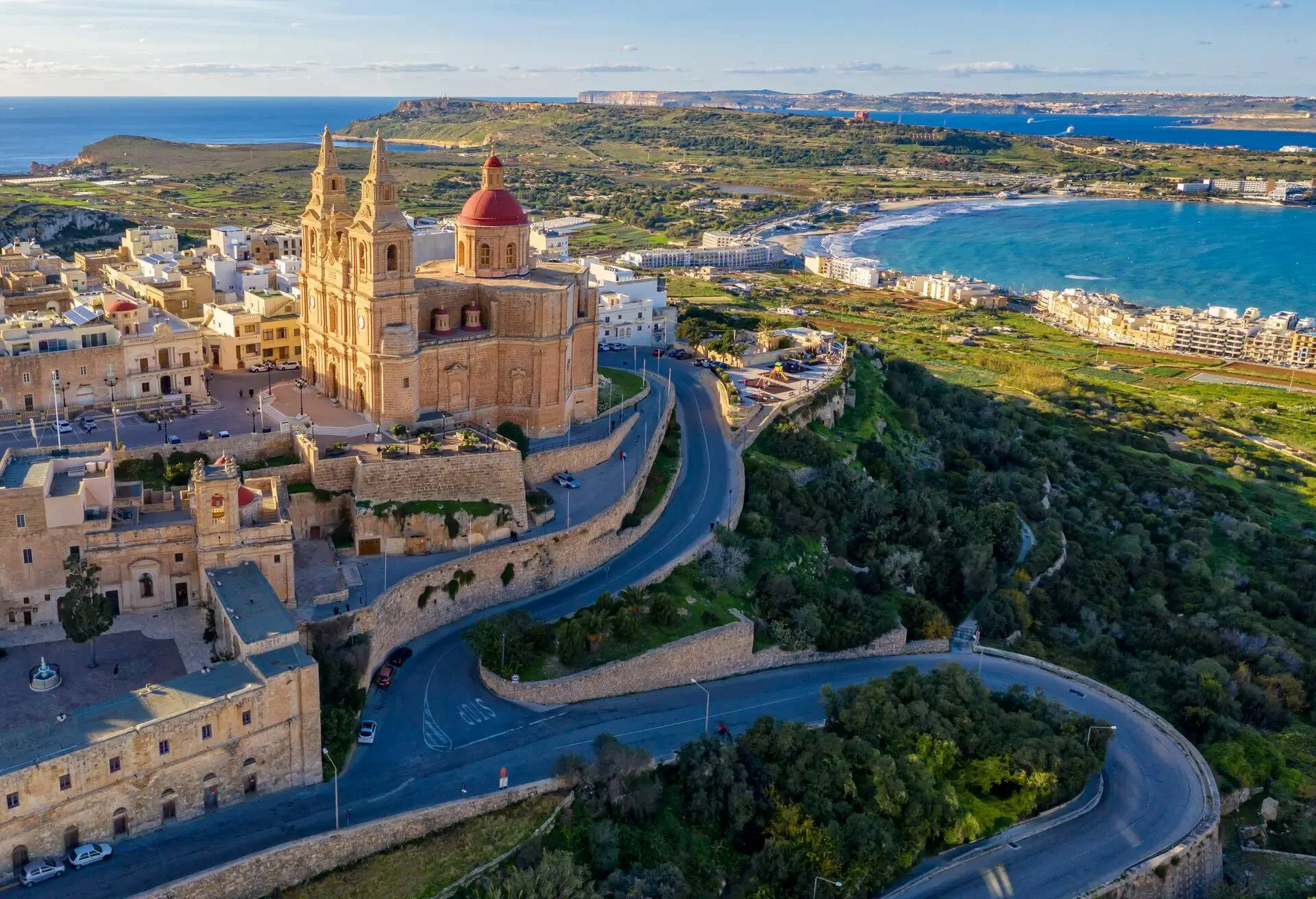 The beautiful Parish Church of Mellieha sits on a hill overlooking Mellieha Bay. Photo was taken from above by a drone.