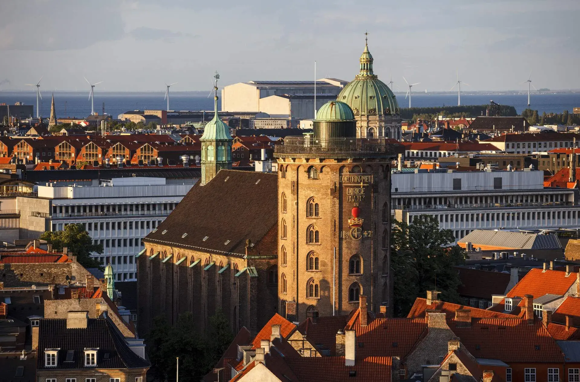 A Baroque architecture observatory tower among the classic buildings of an old city.
