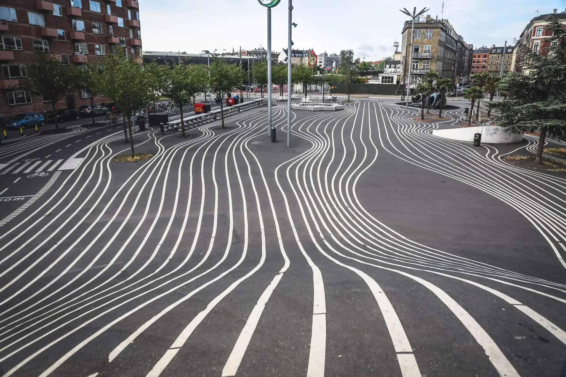 Winding white lines on the road surrounded by classic buildings.