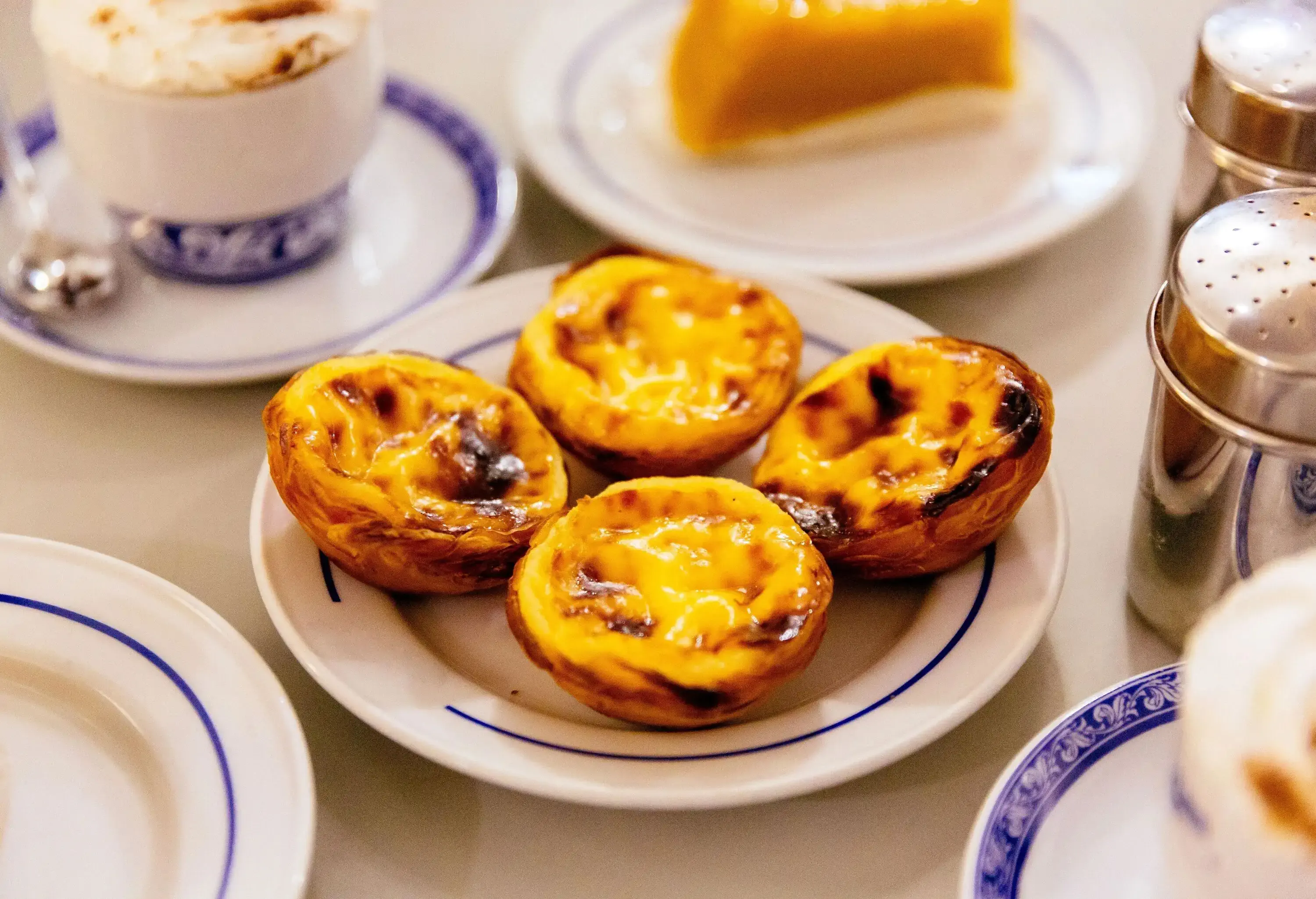 Pasteis de Nata are delectable custard tarts featuring a crispy, flaky crust and a creamy, rich filling.
