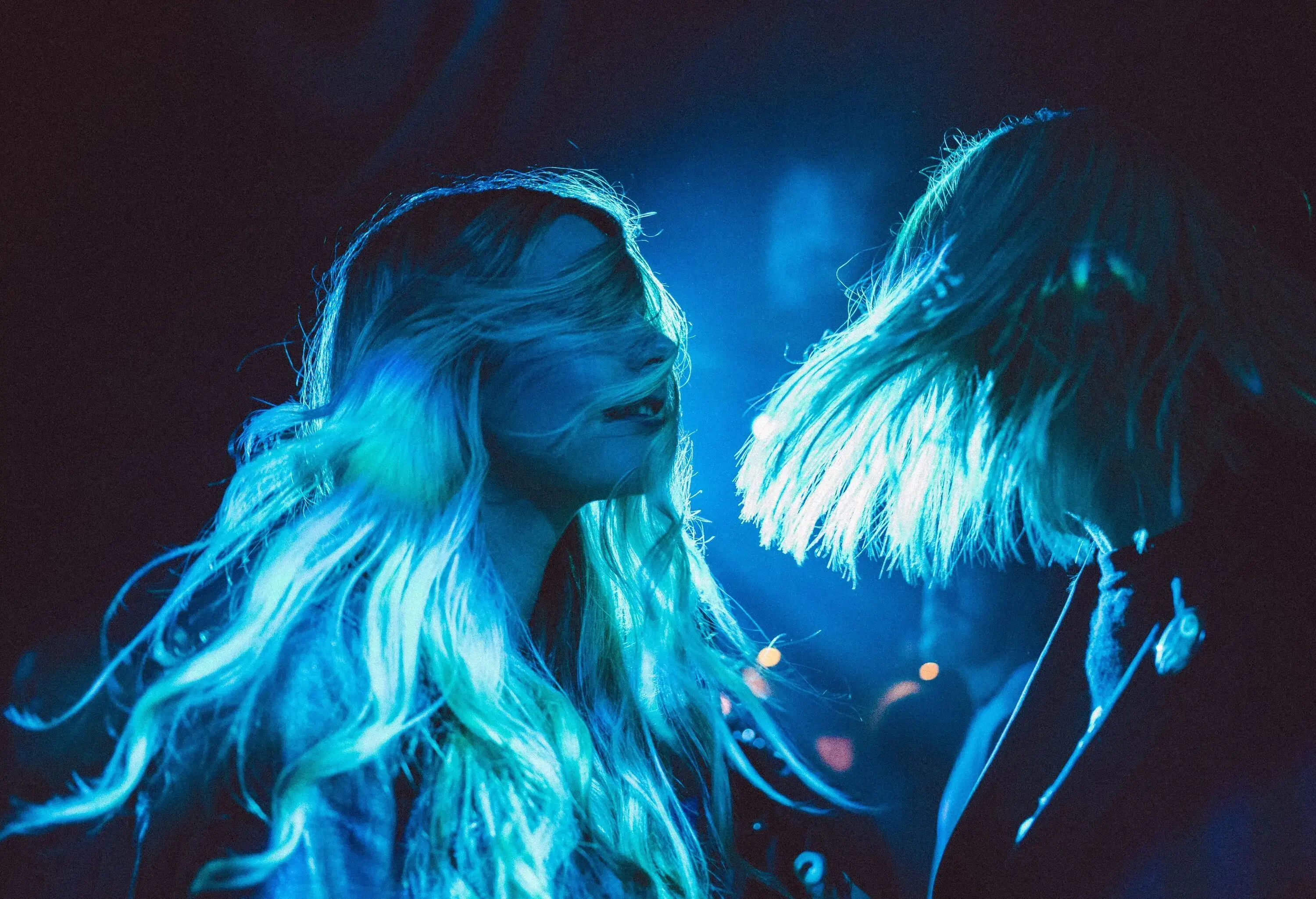 Young ladies enjoying a fun night out together. Dancing at a live music gig.