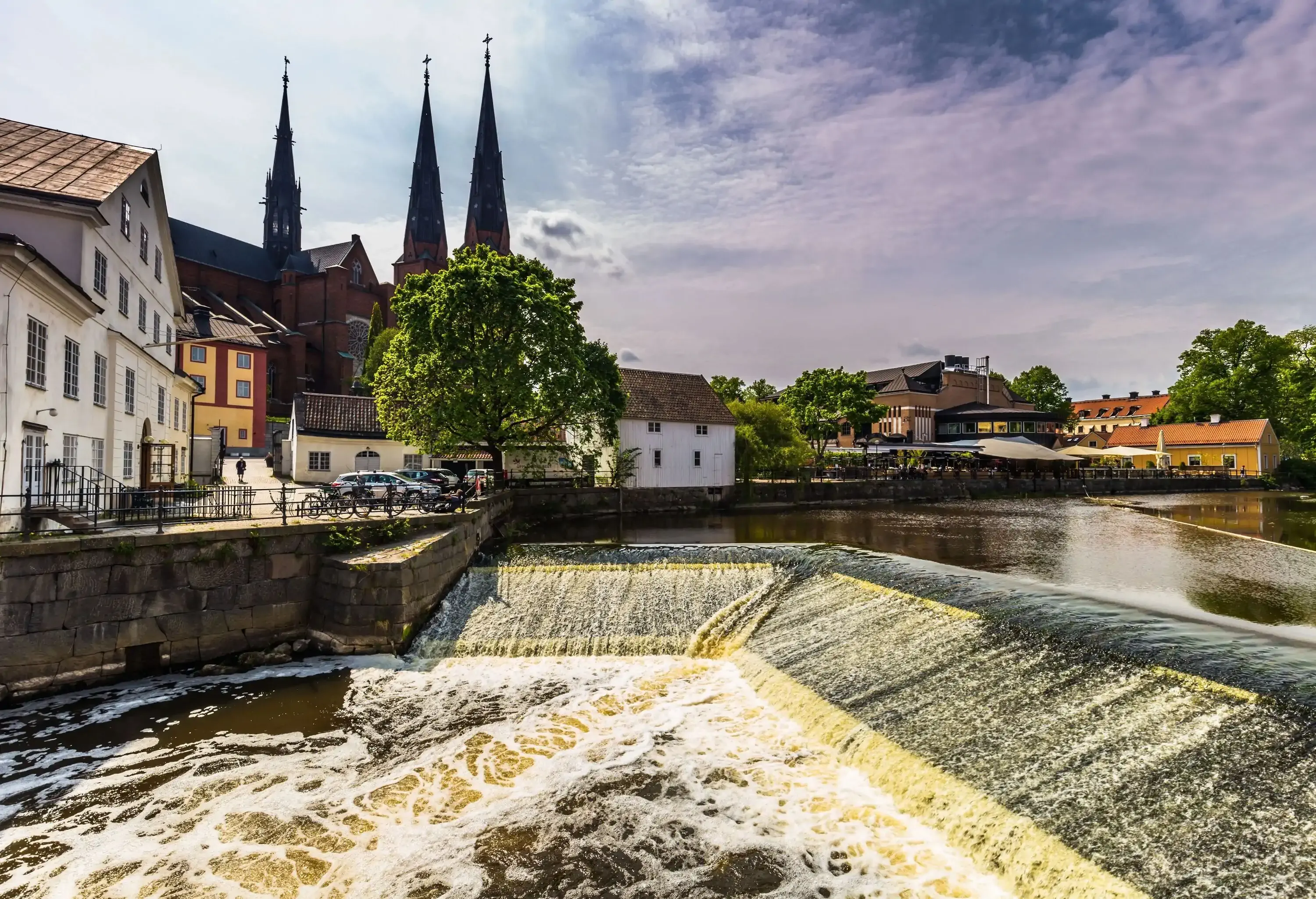 River water pouring into a dam in an old town.