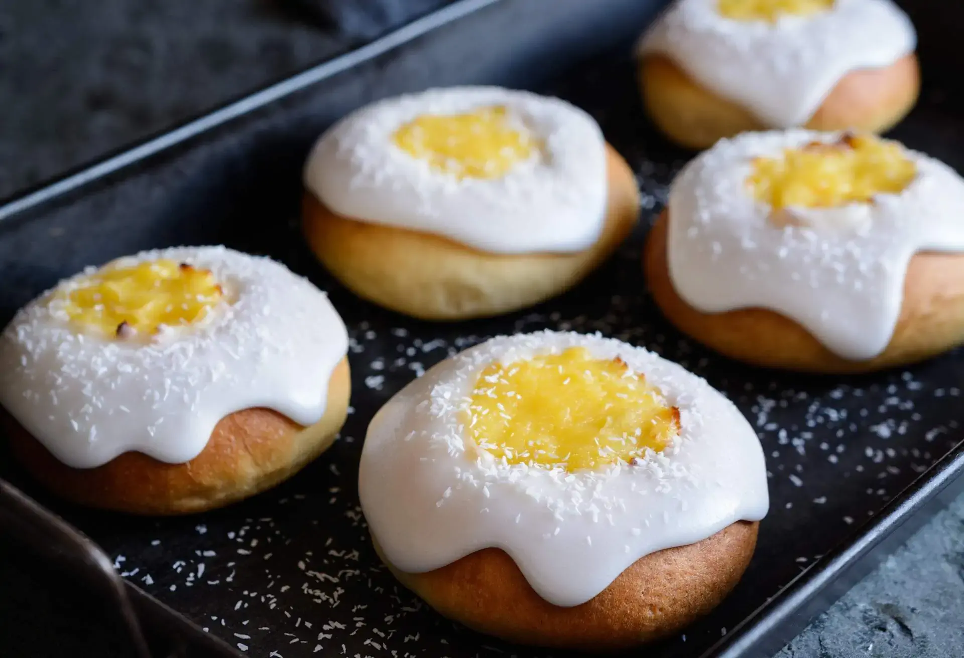 Skoleboller, traditional Norwegian buns with custard filling, sugar glazing and sprinkled with shredded coconut 
