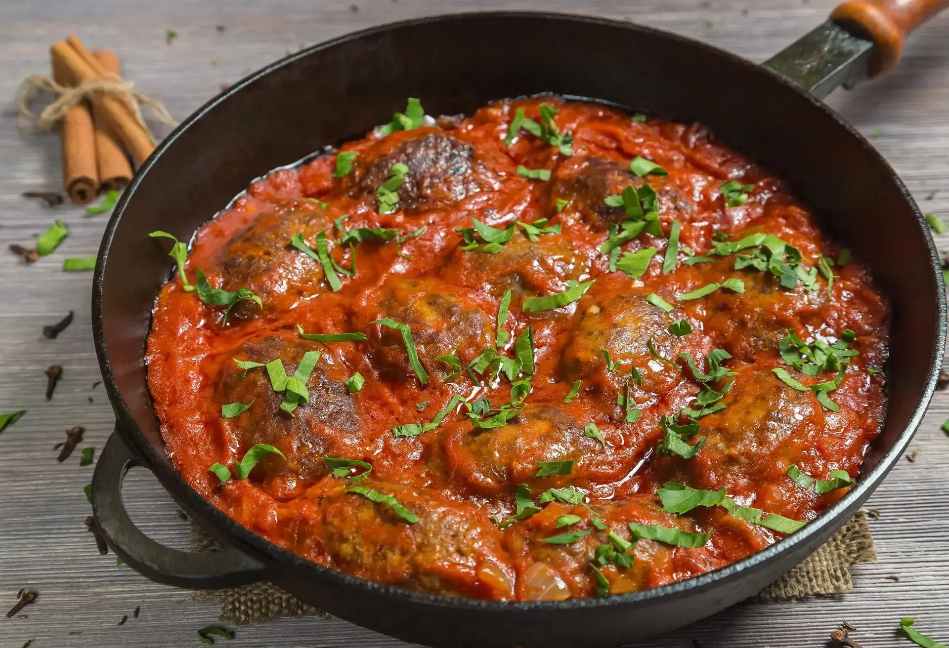 Soutzoukakia in a black cast iron pan