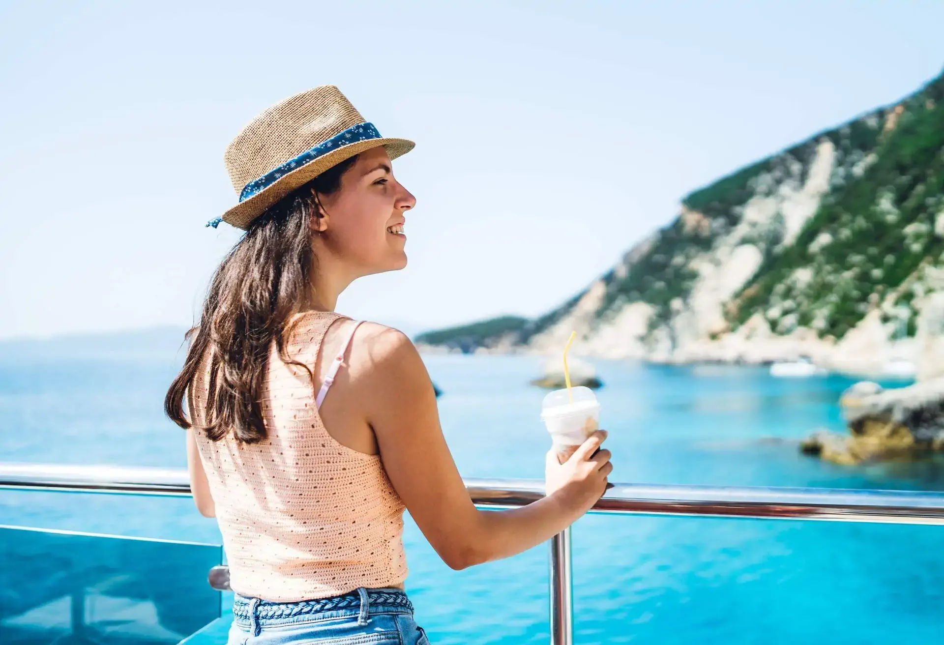 Woman on a boat overlooking the water in Greece