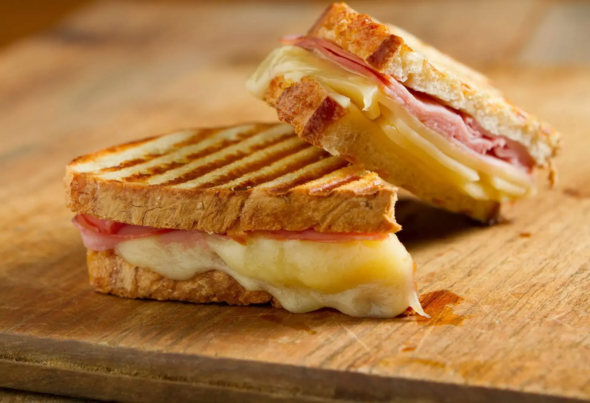 Croque Monsieur with ham and cheese on a wooden board