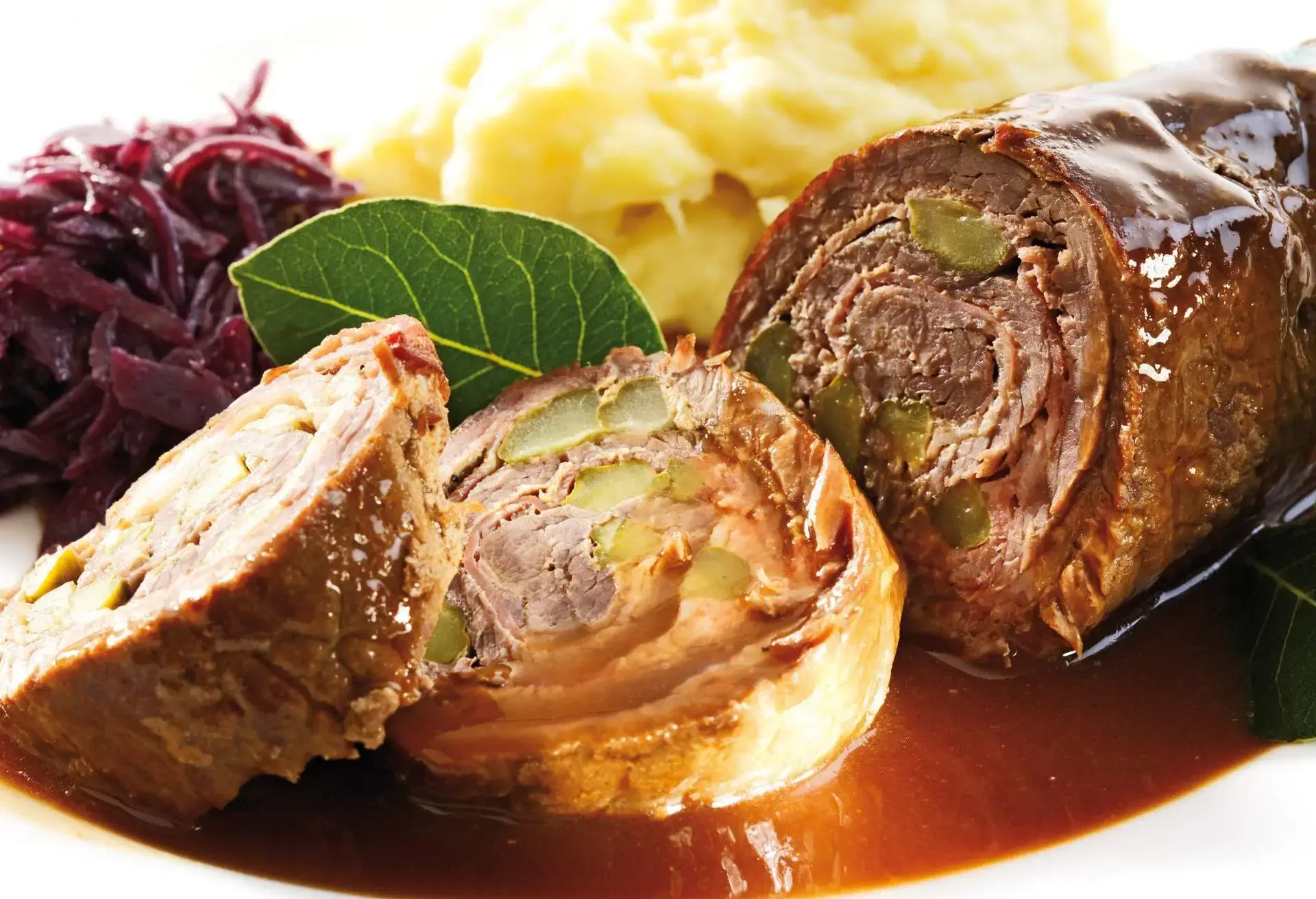 Slices of Roulade with sauce, red cabbage and potato puree