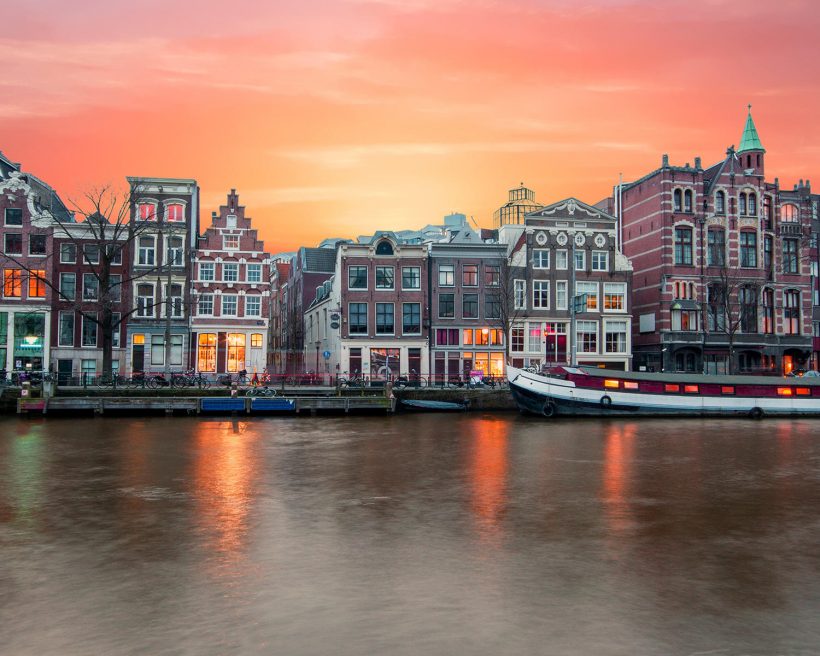 Amsterdam at the river Amstel at sunset in the Netherlands