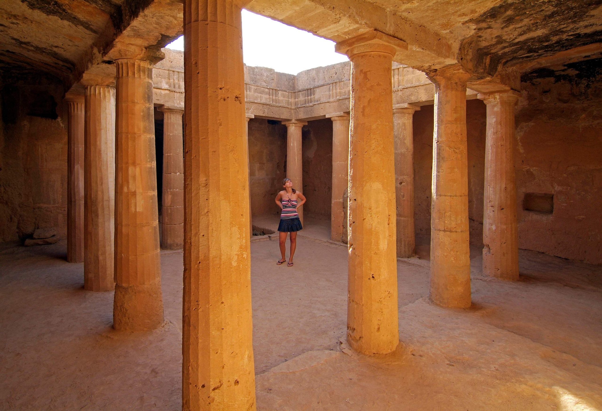 A lady tourist looking at the underground columns built during ancient times.