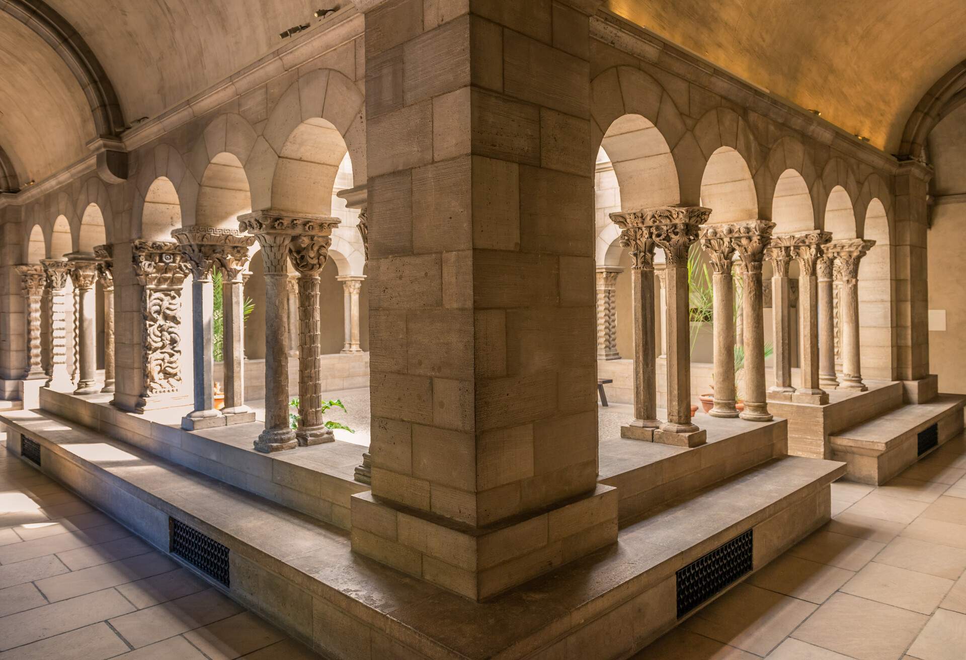 The cloister arch perspective in The Cloisters offers a captivating view, drawing the eye along a series of arched passageways that converge in the distance.