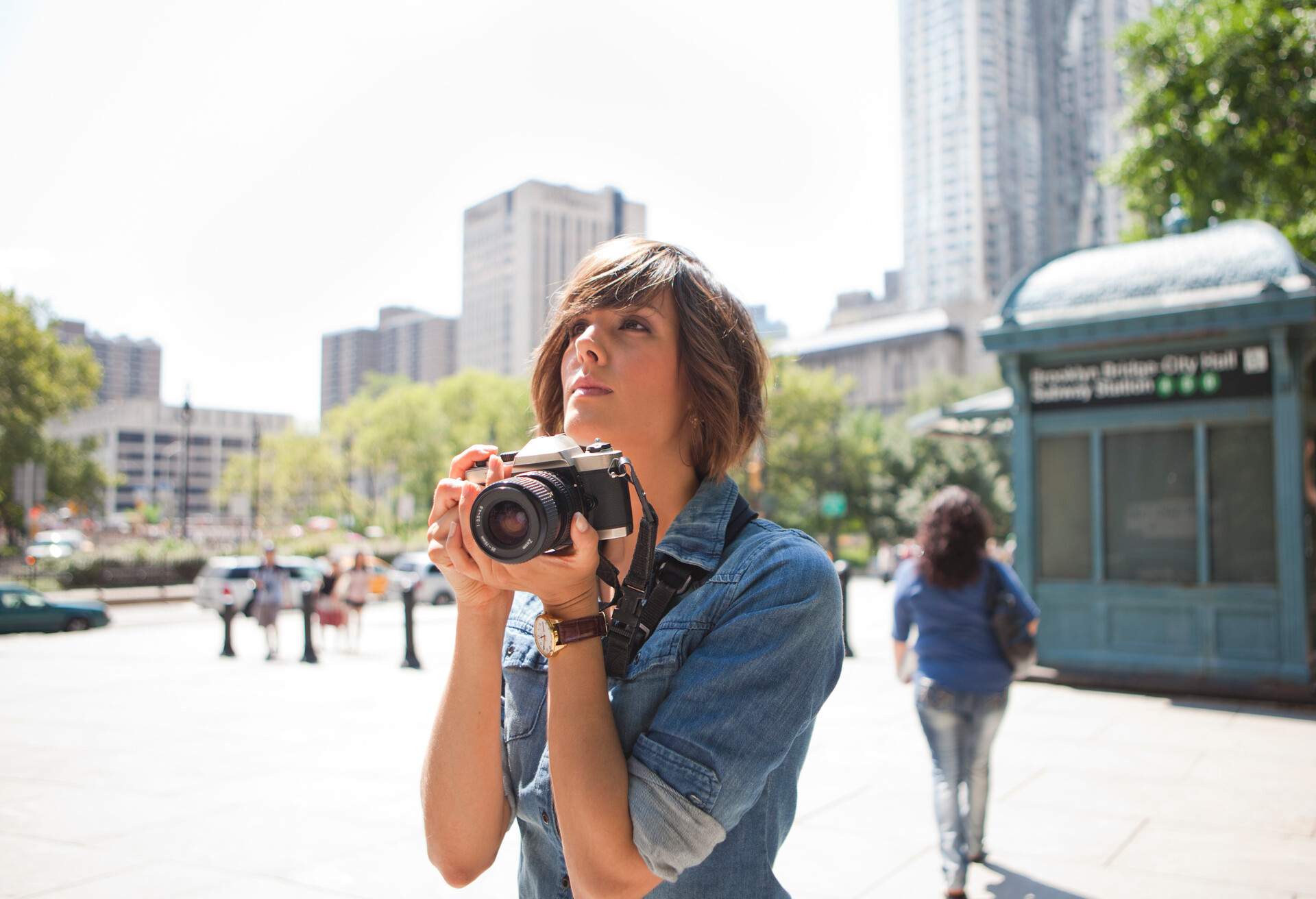 A lady traveller wanders around the city with her camera.