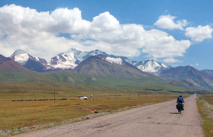 Pamir highway or pamirskij trakt with biker. Landscape around Pamir highway M41 international road, mountains in Kyrgyzstan and Tajikistan
