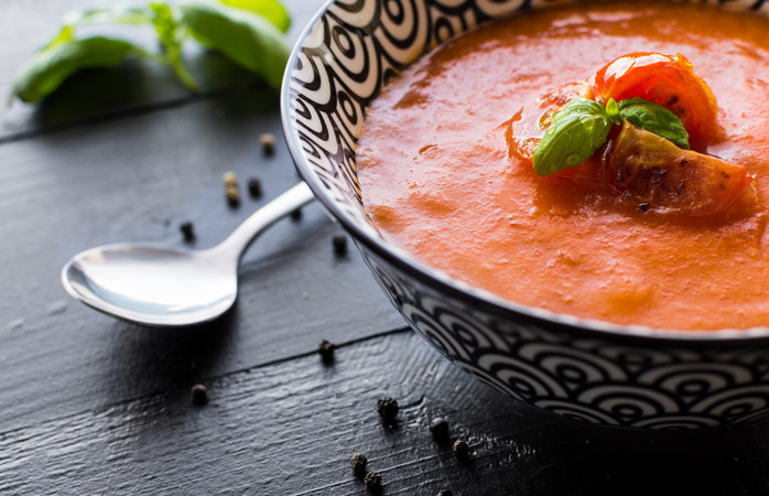 Vegetarian Tomato Soup on Dark Wooden Background