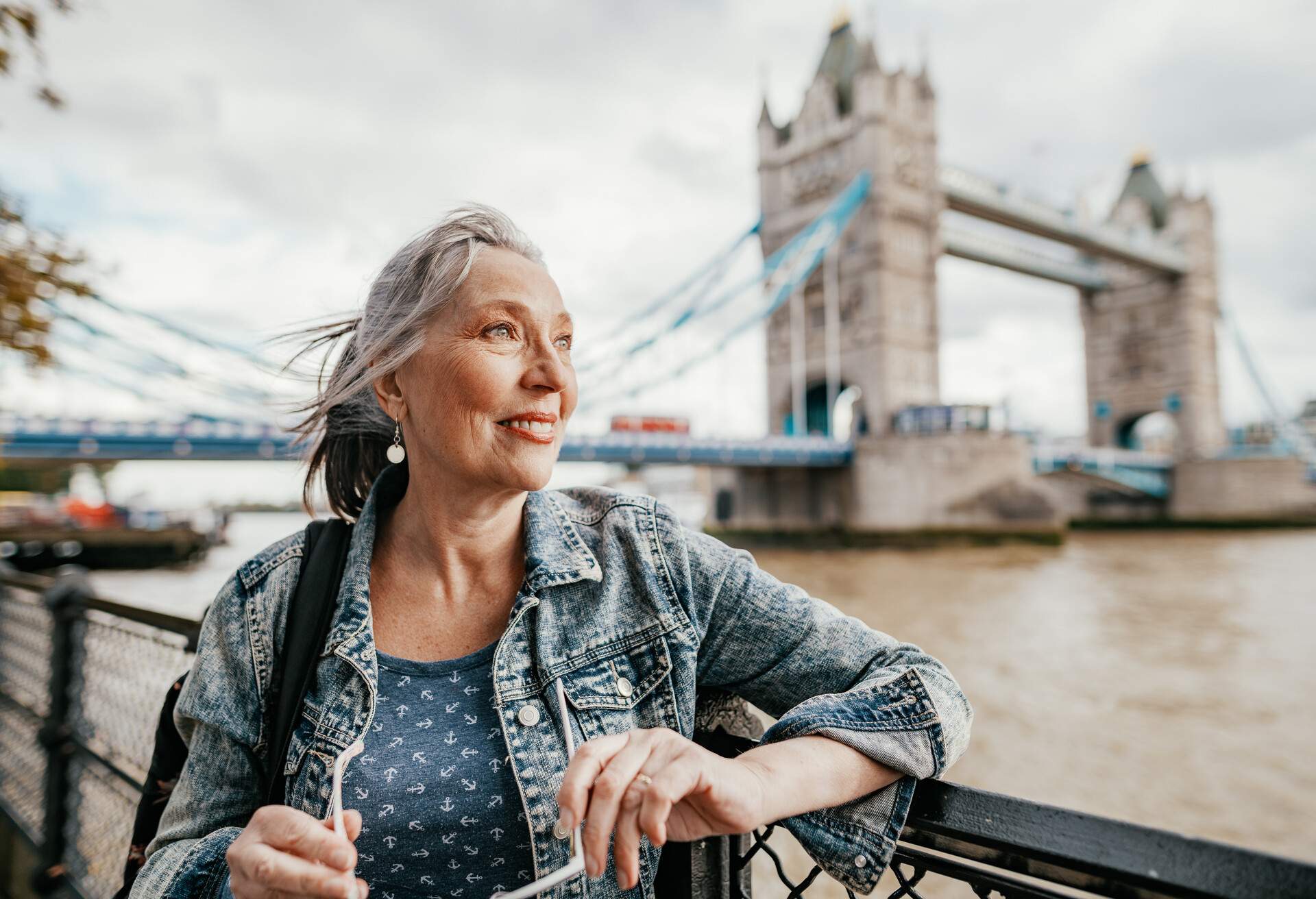 DEST_UK_ENGLAND_LONDON_PEOPLE_SENIR_WOMAN_TOWER_BRIDGE_THAMES_RIVER_GettyImages-1242986499 copy