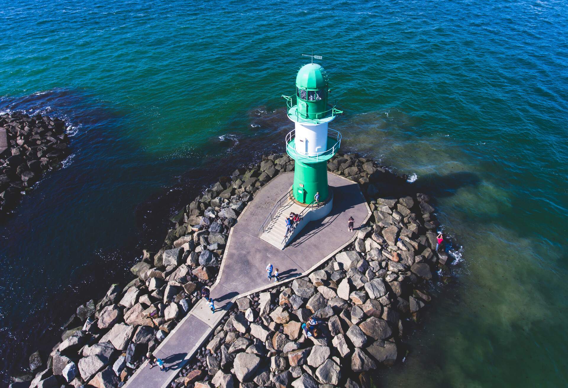 Beautiful summer vibrant view of Warnemunde, Rostock, Germany, popular german seaside resort, with beach, seashore and lighthouse; Shutterstock ID 711088756; Purpose: Product; Brand (KAYAK, Momondo, Any): Any