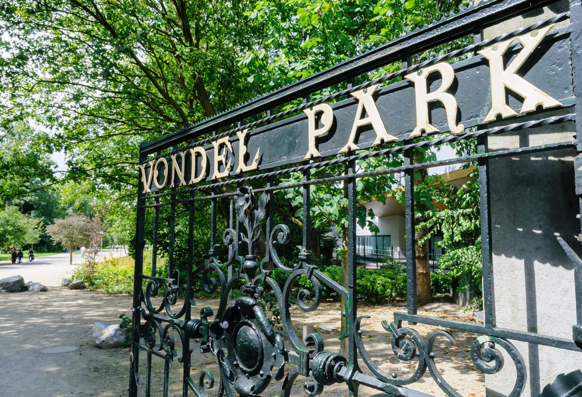 A wrought iron gate with letters that spell VONDEL PARK on it.