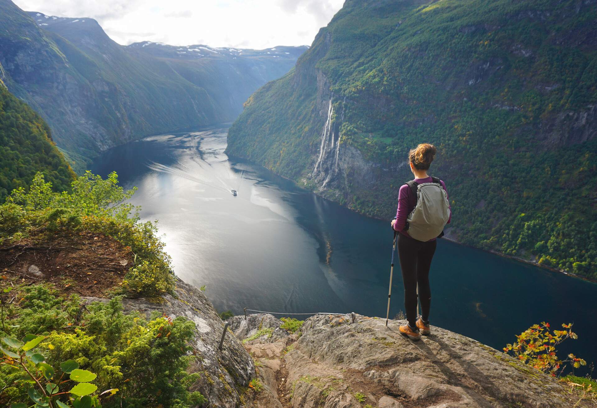 Hiker admiring 7 sisters waterfall in Norway, Geiranger Fjord