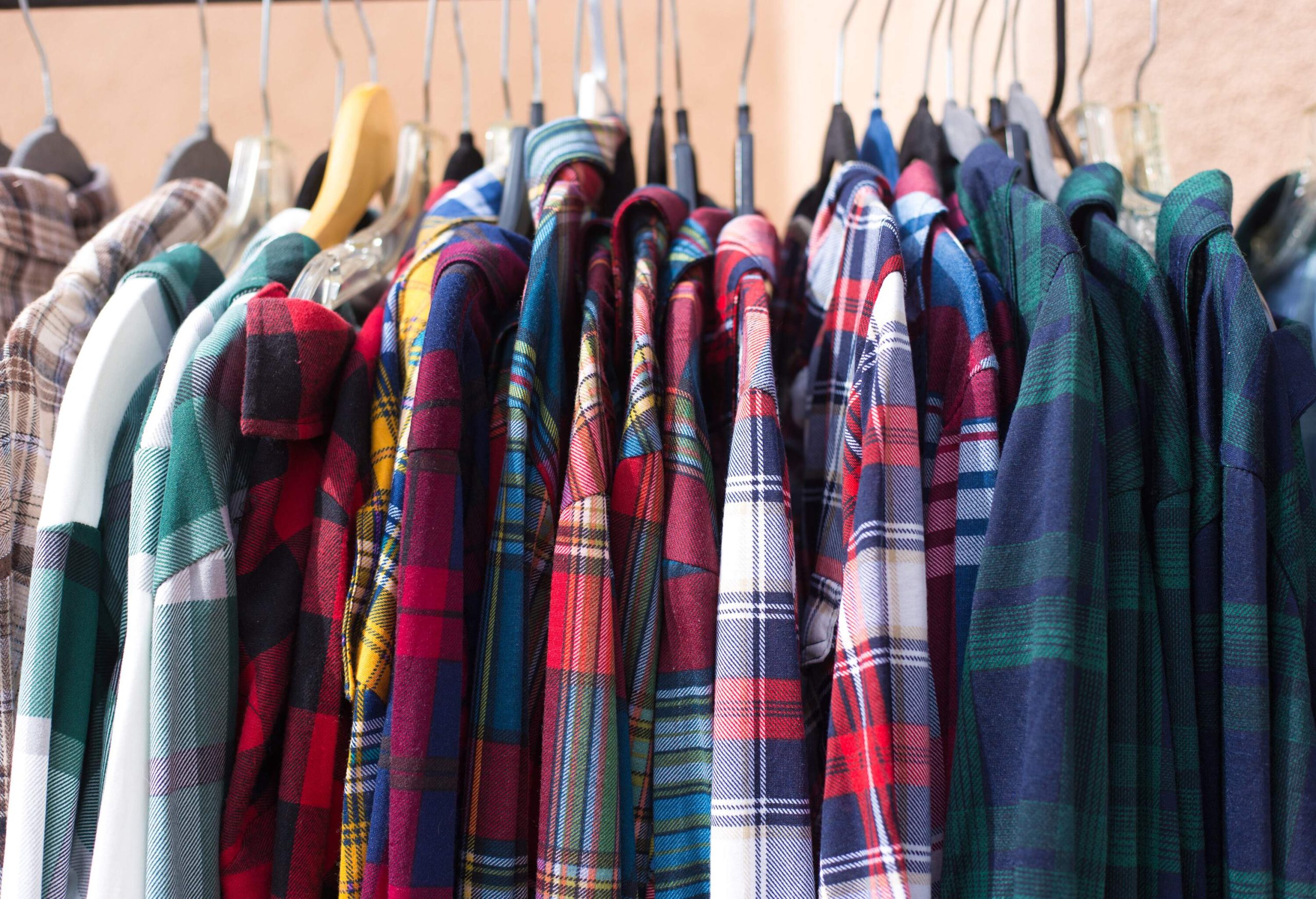 A display of hanged colourful plaid shirts.