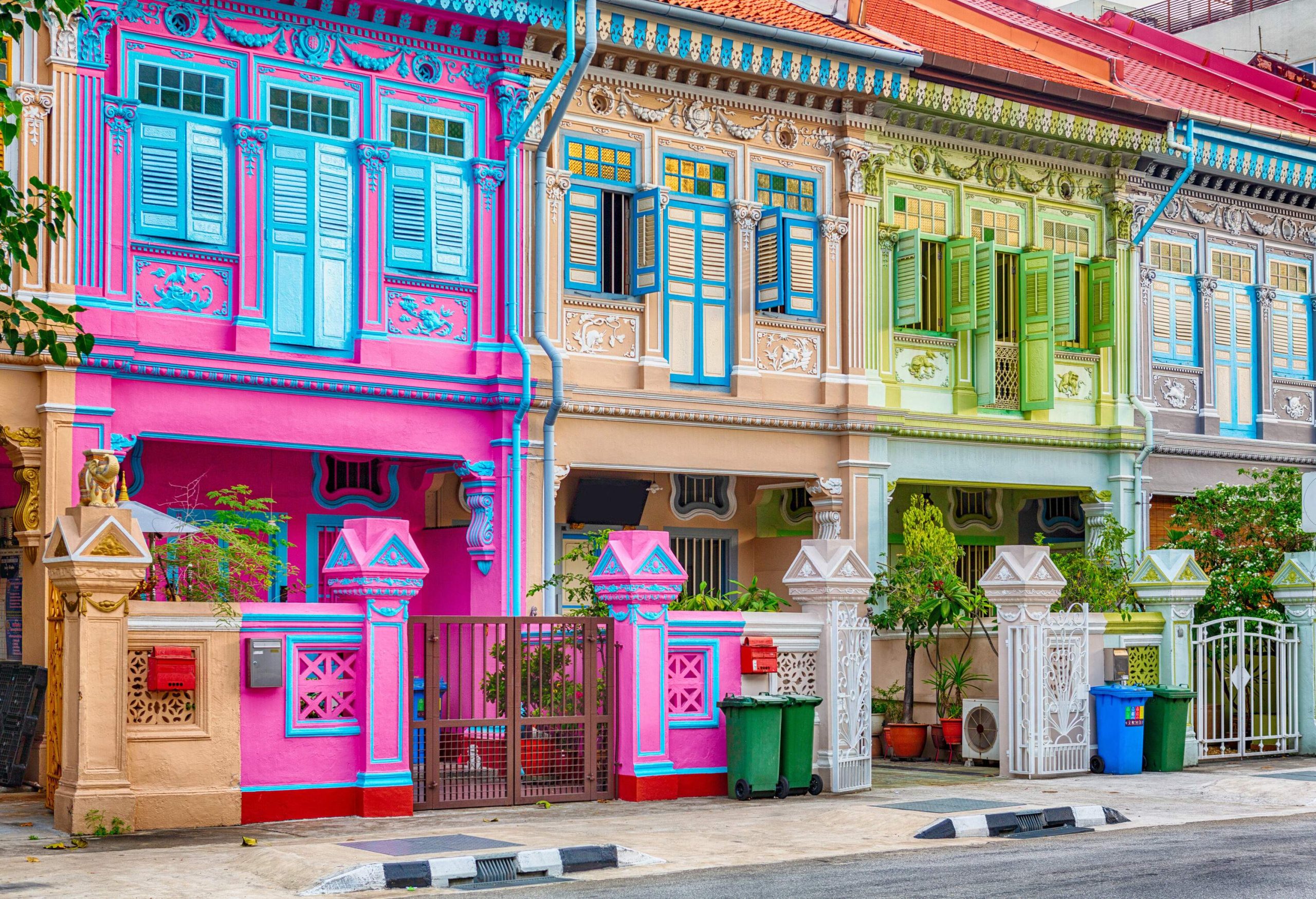 Colourful two-story buildings create a vibrant tapestry as they line the street.