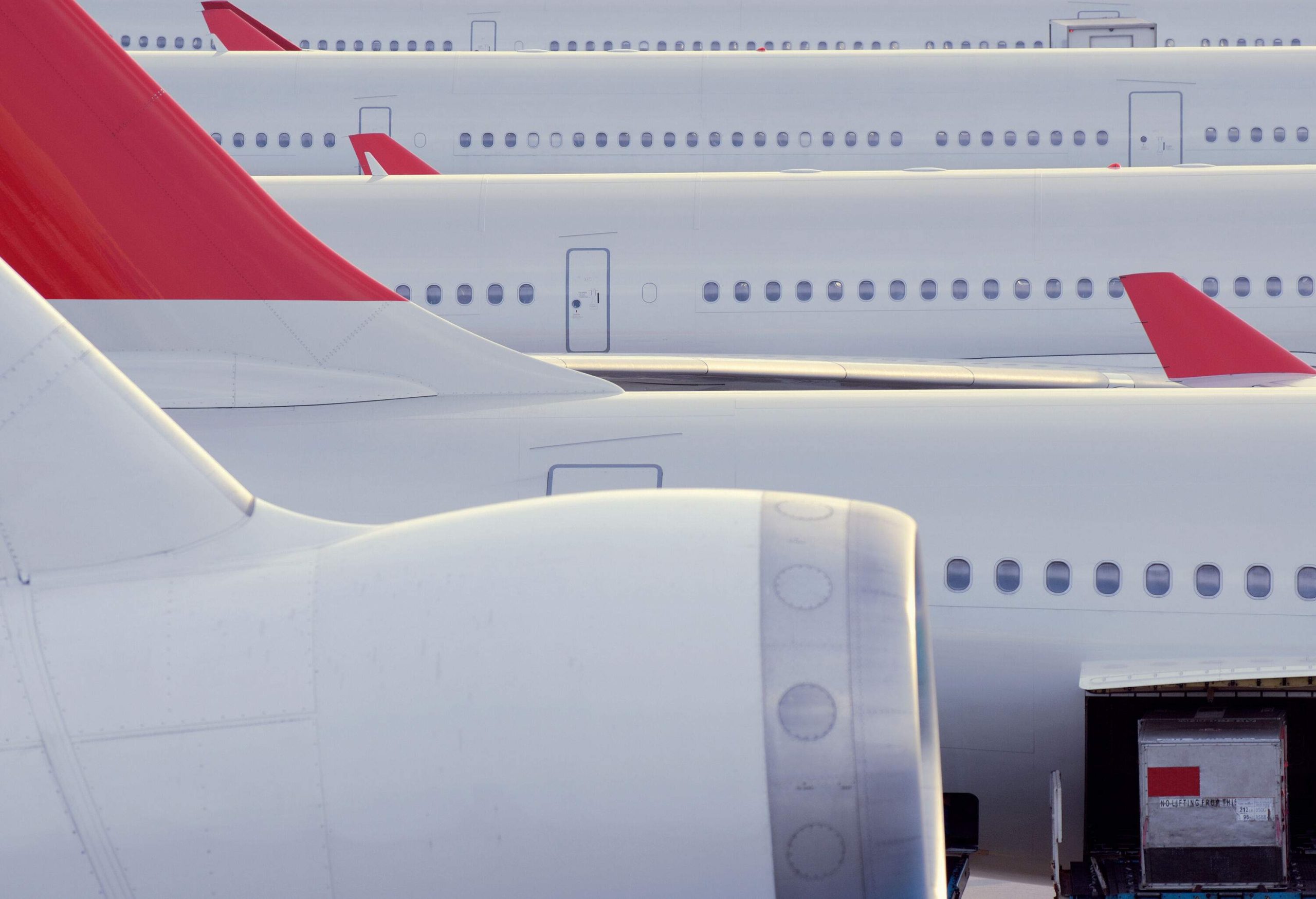 A row of grounded passenger aircraft.