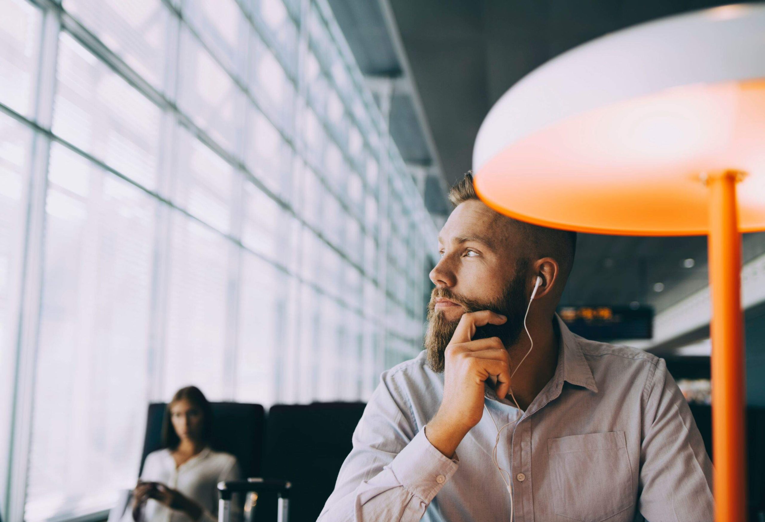 dest_sweden_arlanda_airport_theme_person_man_earphones_airport-lounge_gettyimages-1136195098