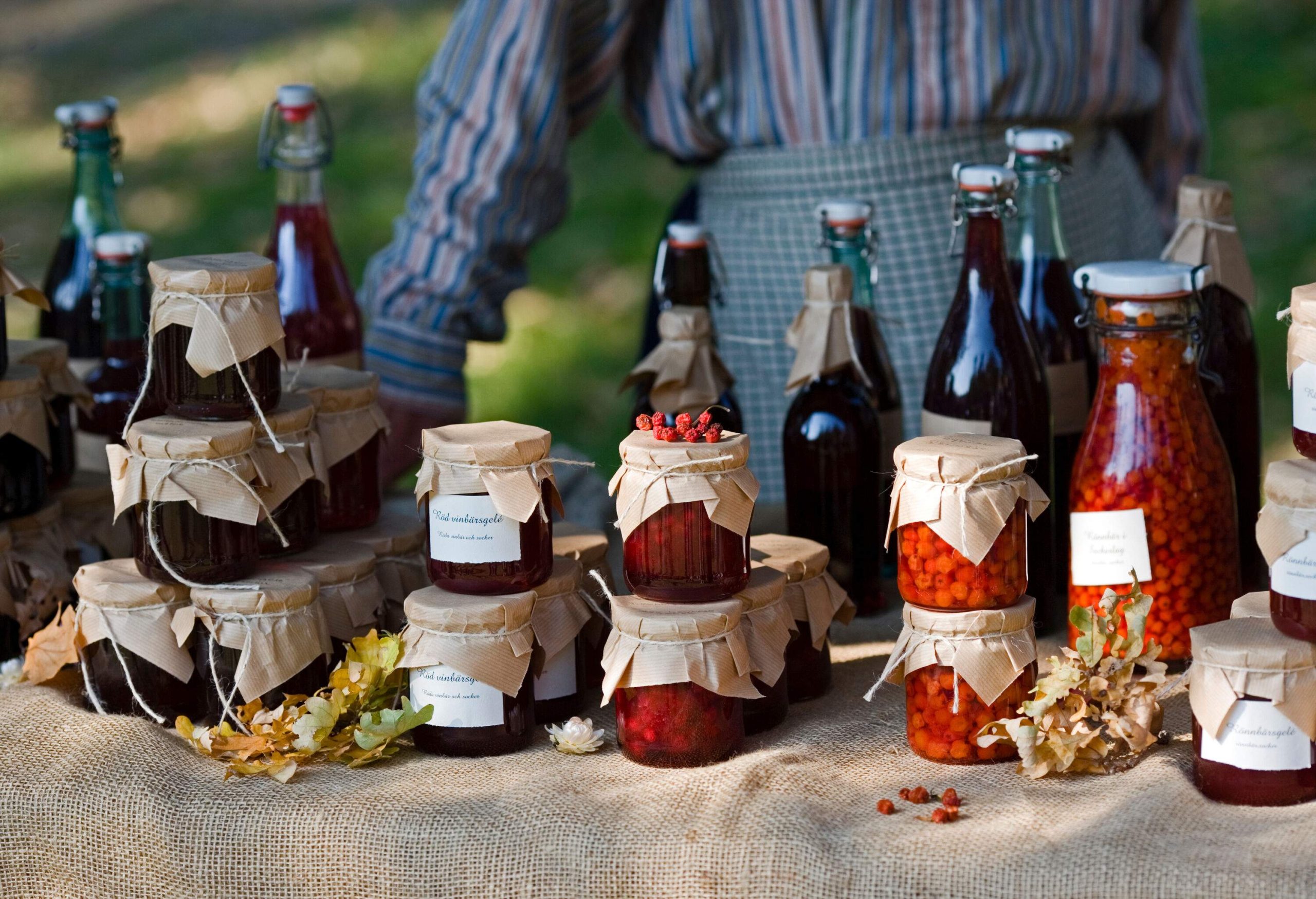 Homemade jars of jam and fruit juices are displayed on the table.