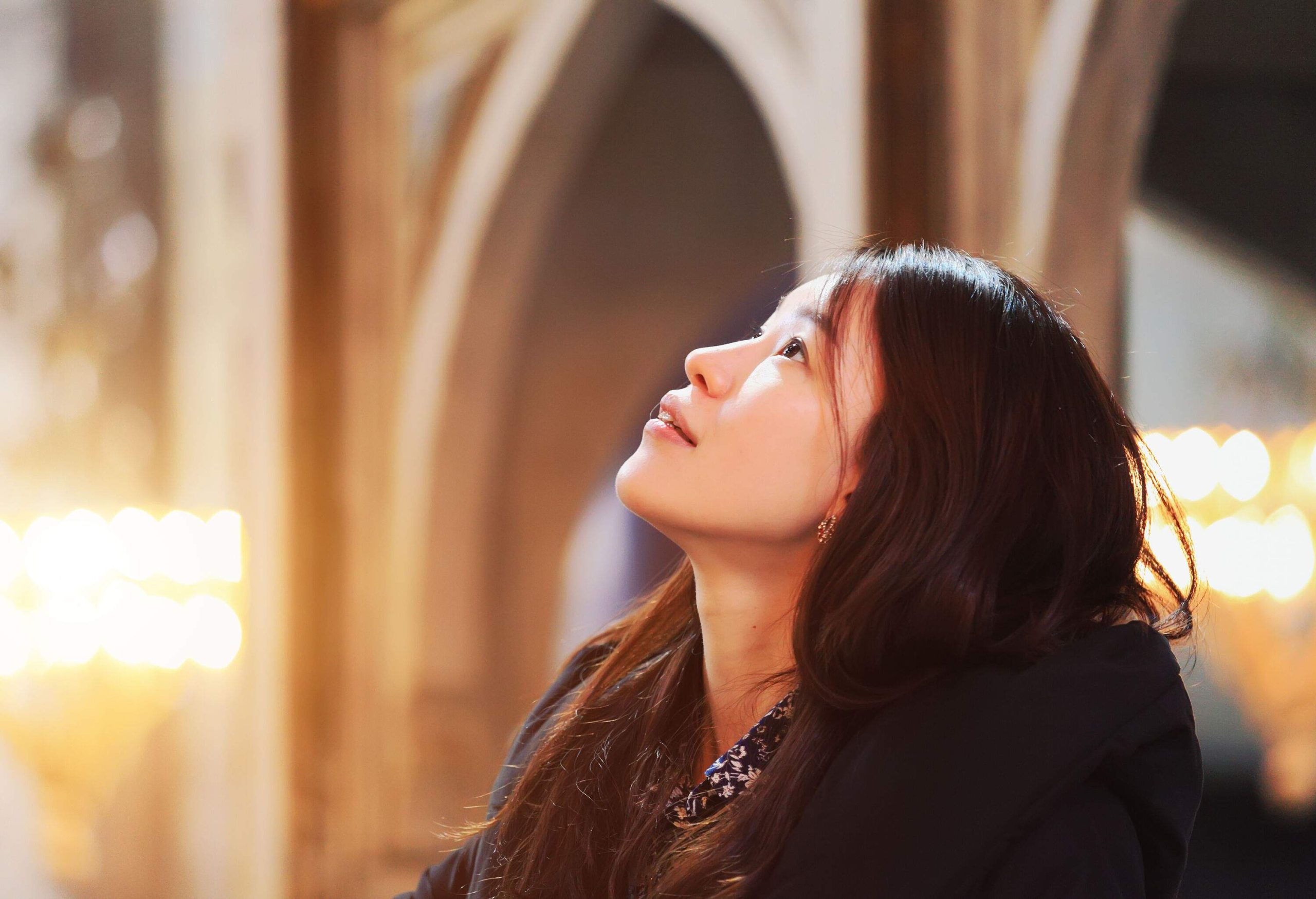 A portrait of a woman against a bokeh background.