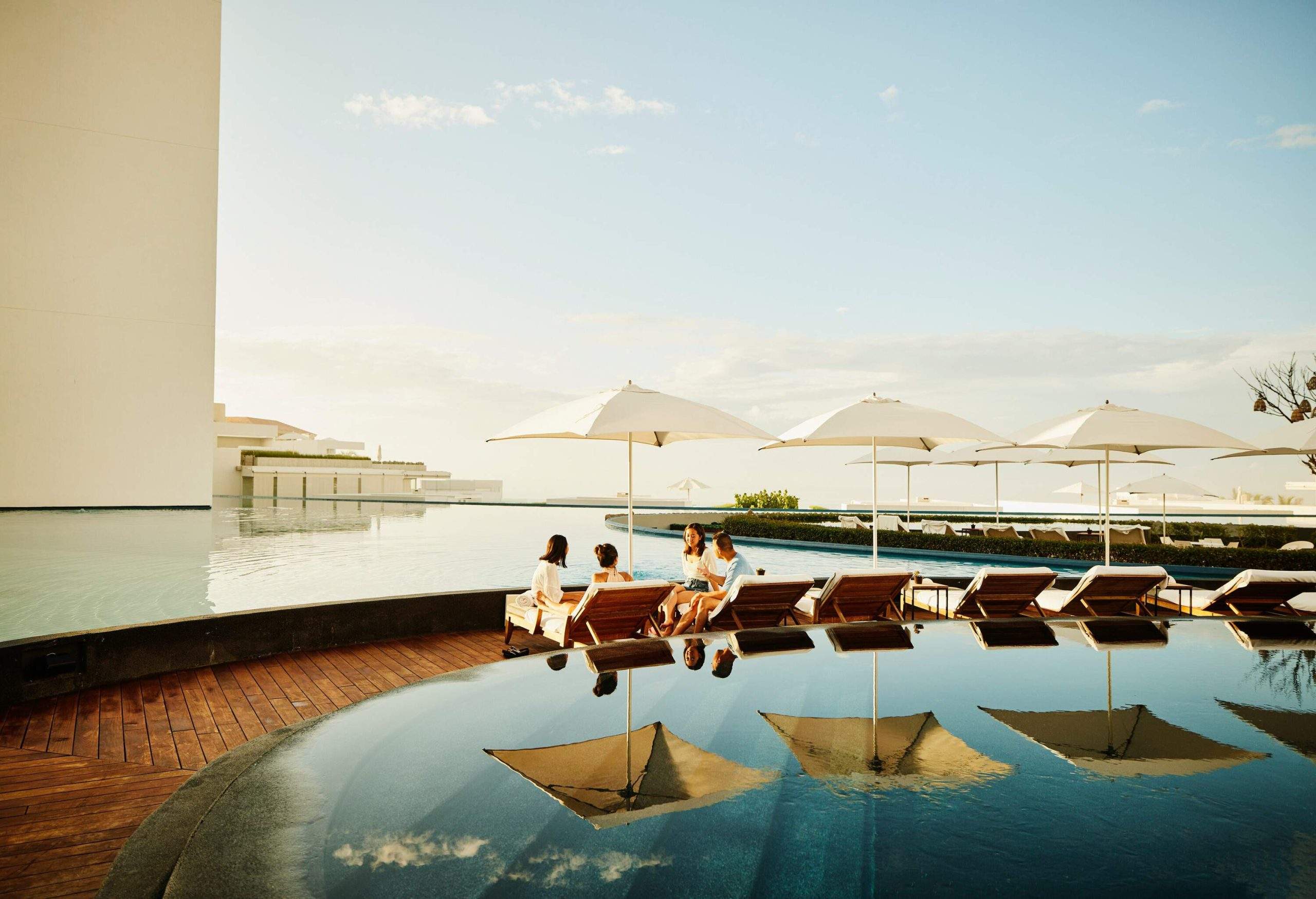 dest_mexico_baja_california_theme_hotel_pool_friends_gettyimages-1447917597-scaled