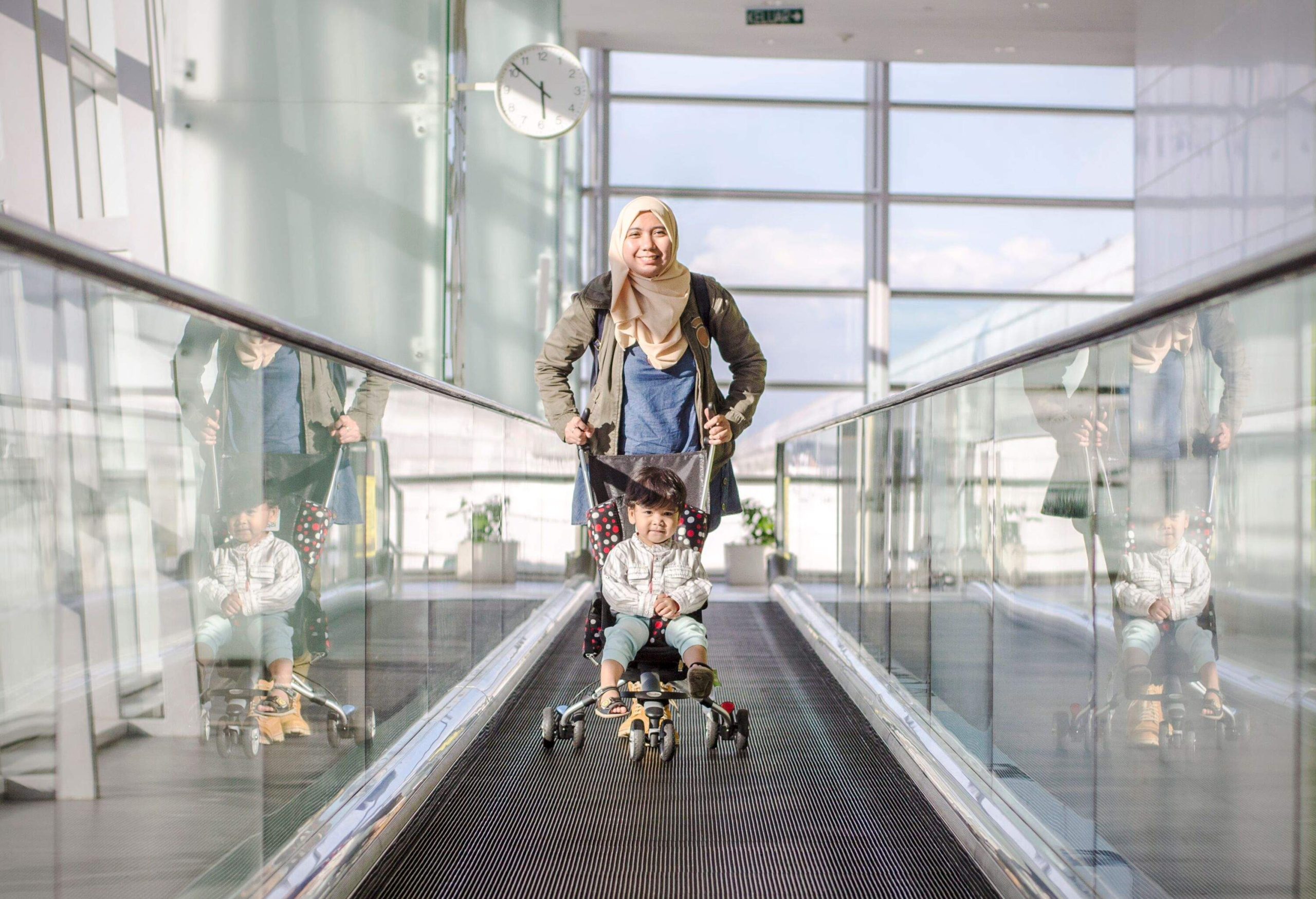 Woman traveling with his baby son at airport