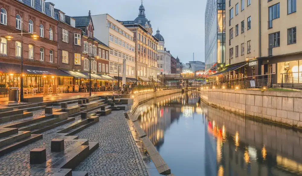 Denmark, Aarhus, view to lighted city with Aarhus River