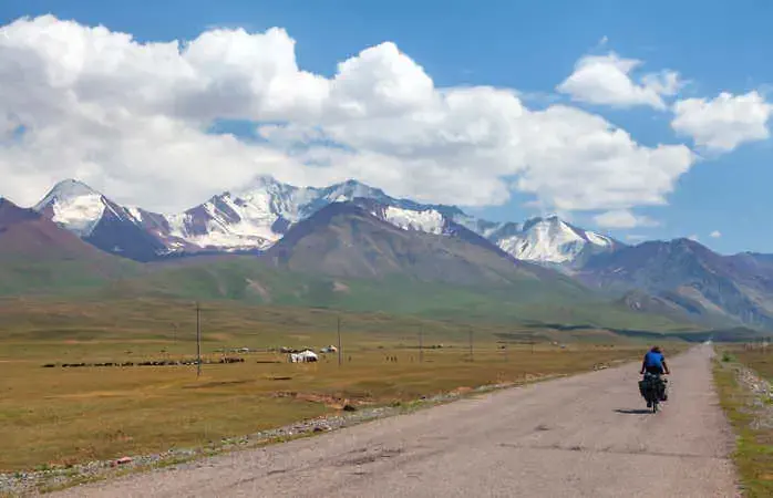Pamir highway or pamirskij trakt with biker. Landscape around Pamir highway M41 international road, mountains in Kyrgyzstan and Tajikistan