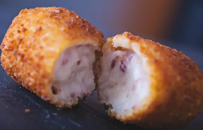Close up of a croqueta, made with bechamel and serrano ham