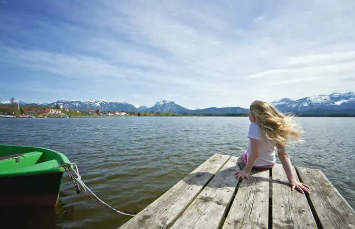 Blonde hair girl at lake Hopfensee.