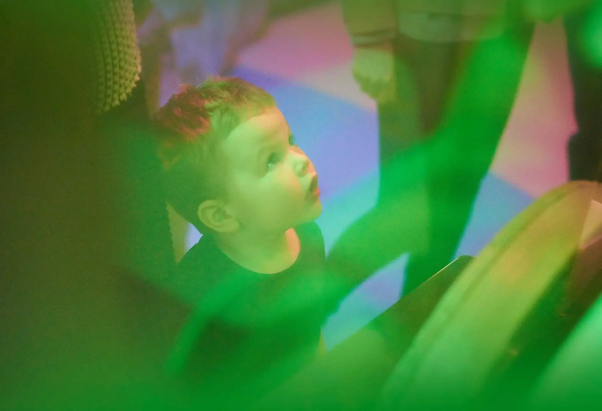 Toddler interacting with toys and educational equipment at nursery or children’s museum