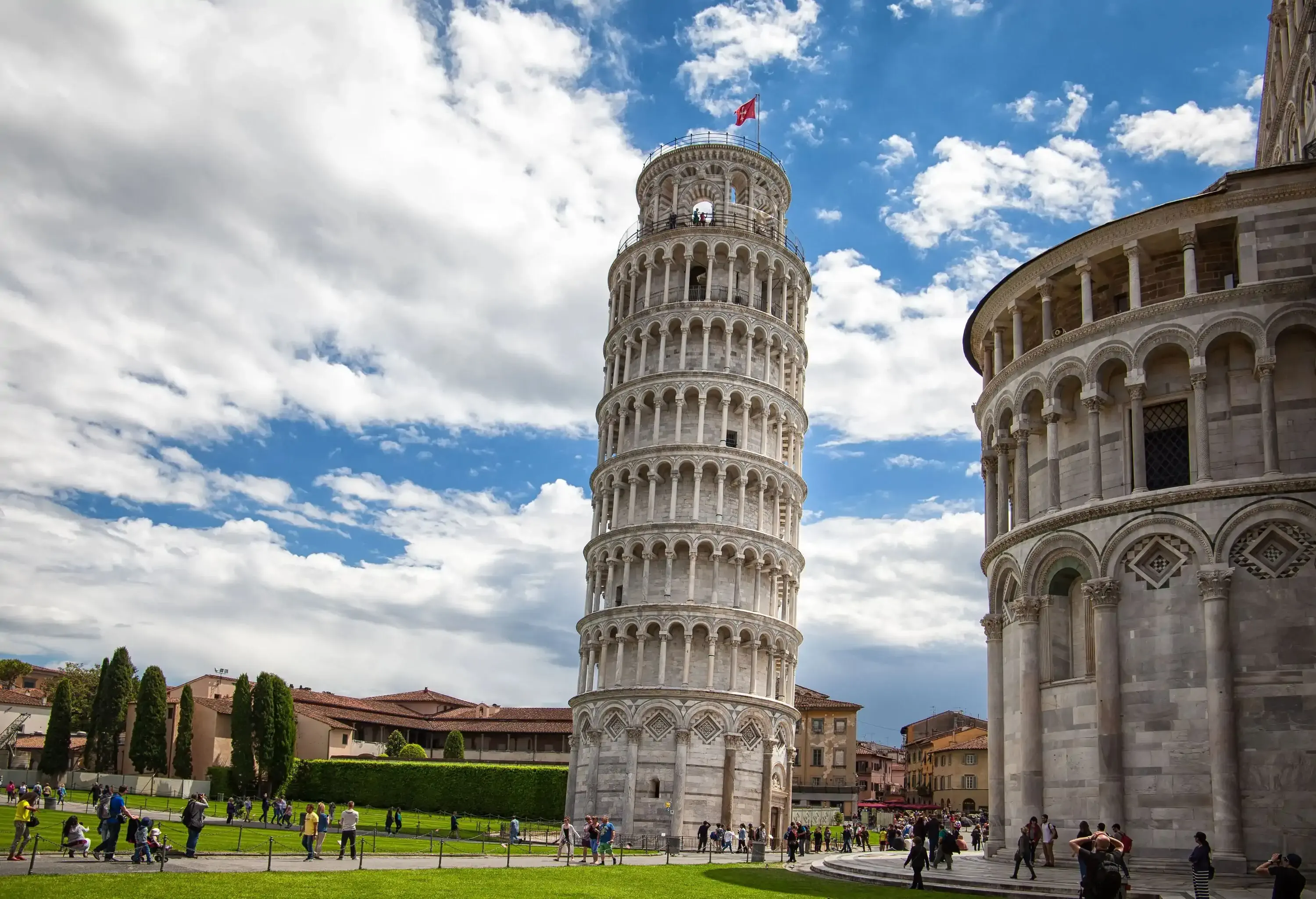 The Leaning Tower of Pisa is a tilted freestanding bell tower designed with marble arches and columns.