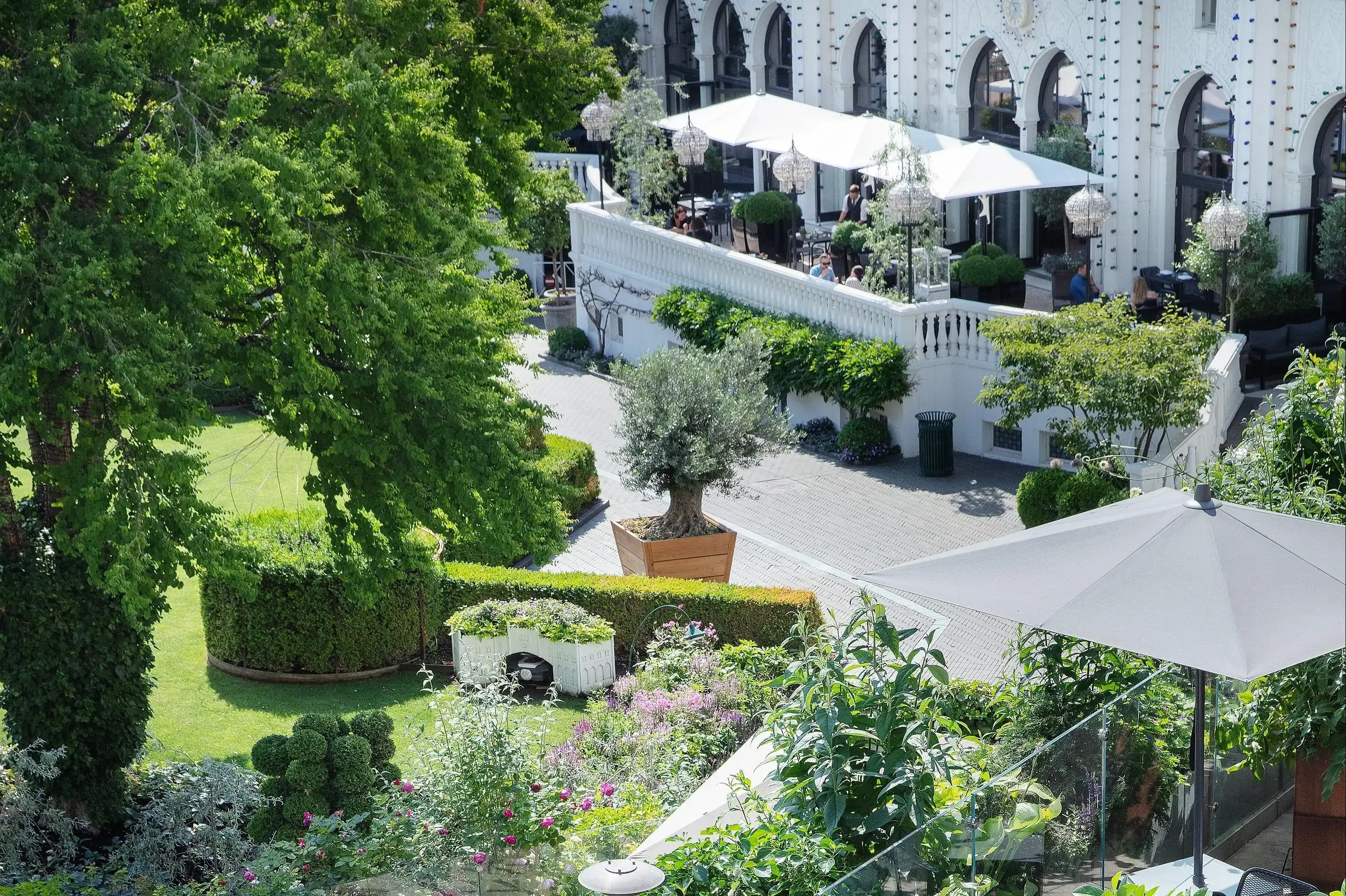 Exterior high angle view view of a garden with patio cafe