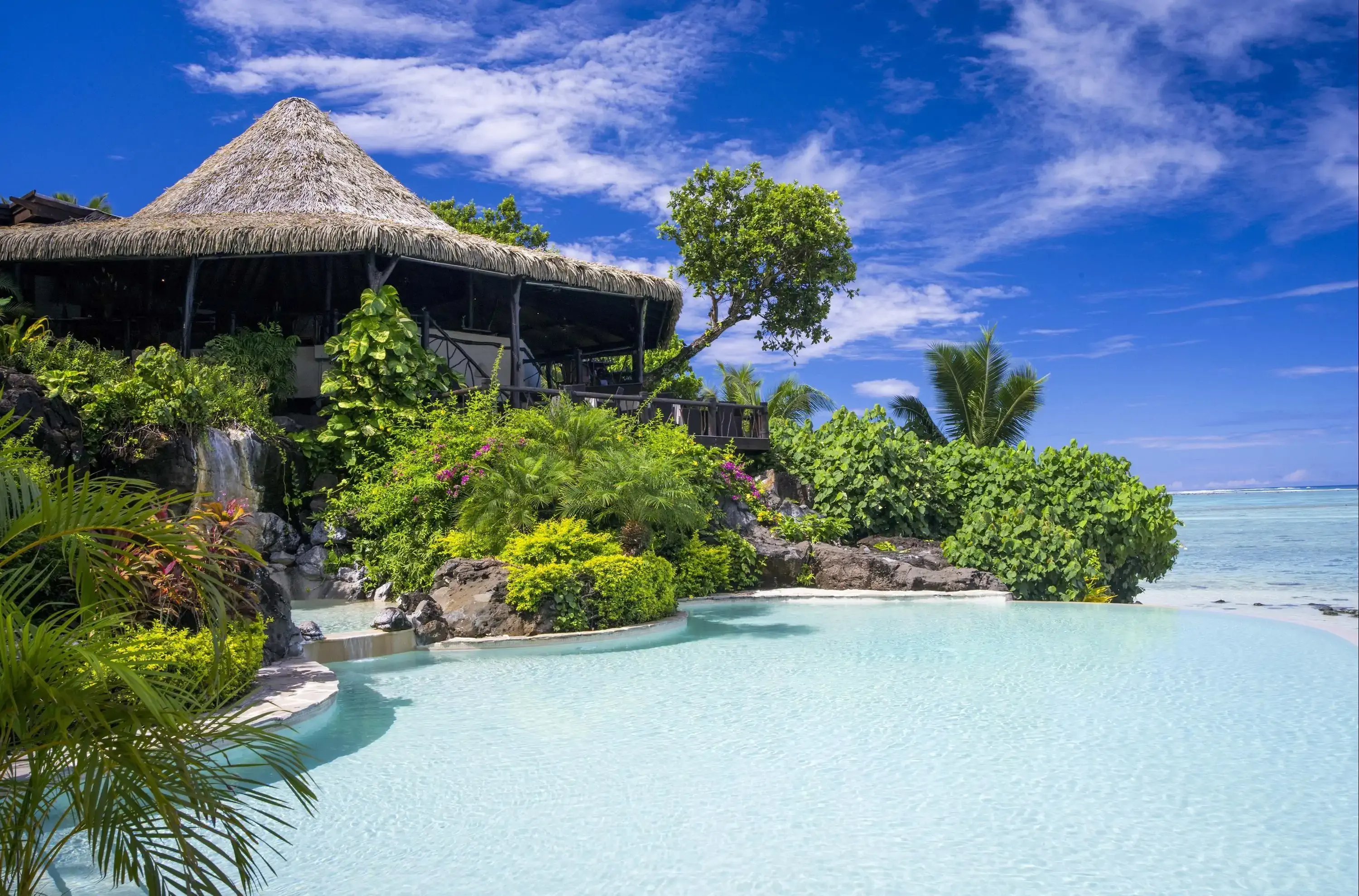 Pool at tropical resort hotel on a sunny day