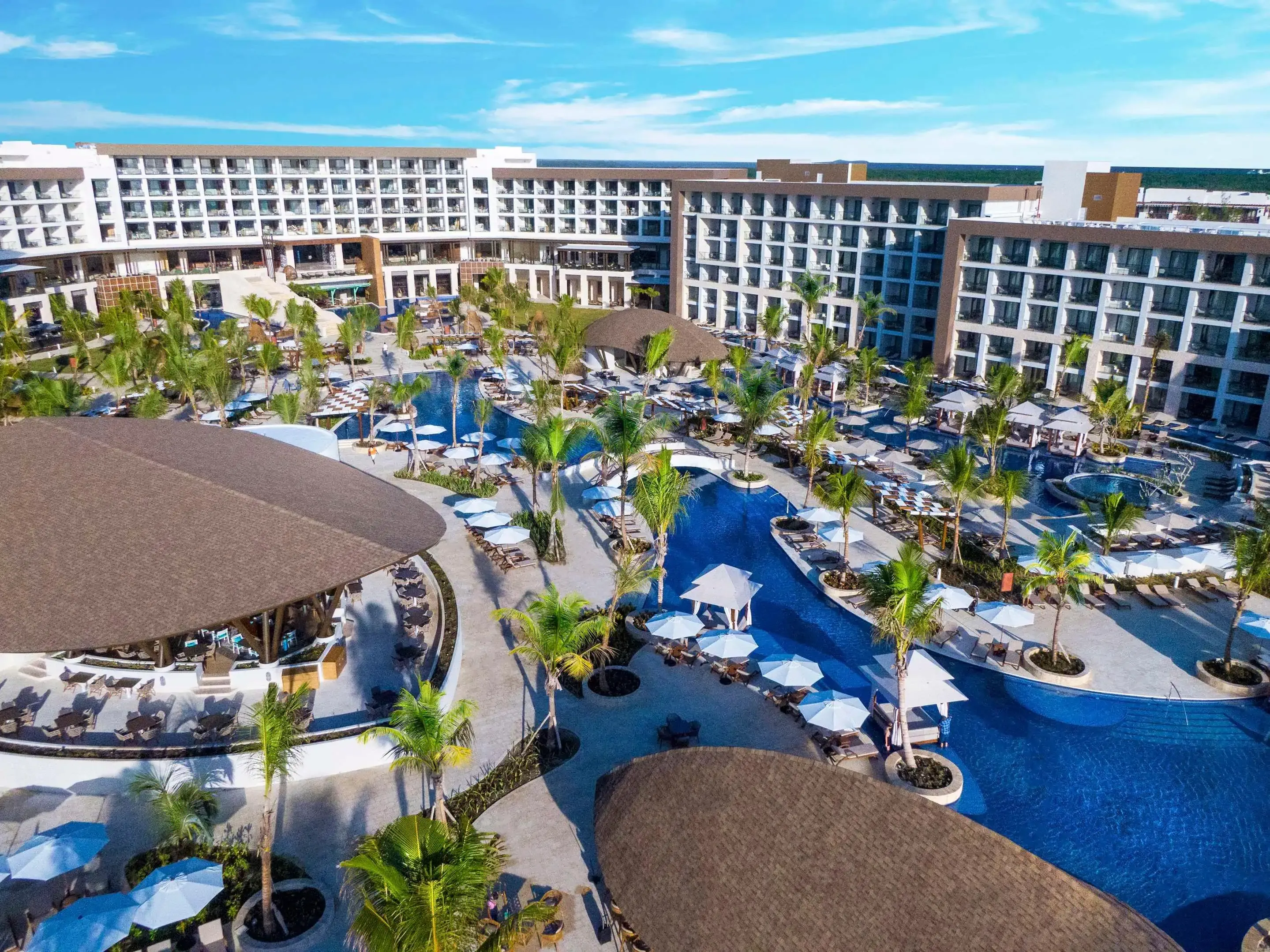 High angle view of a pool running through modern hotel resort with palm trees