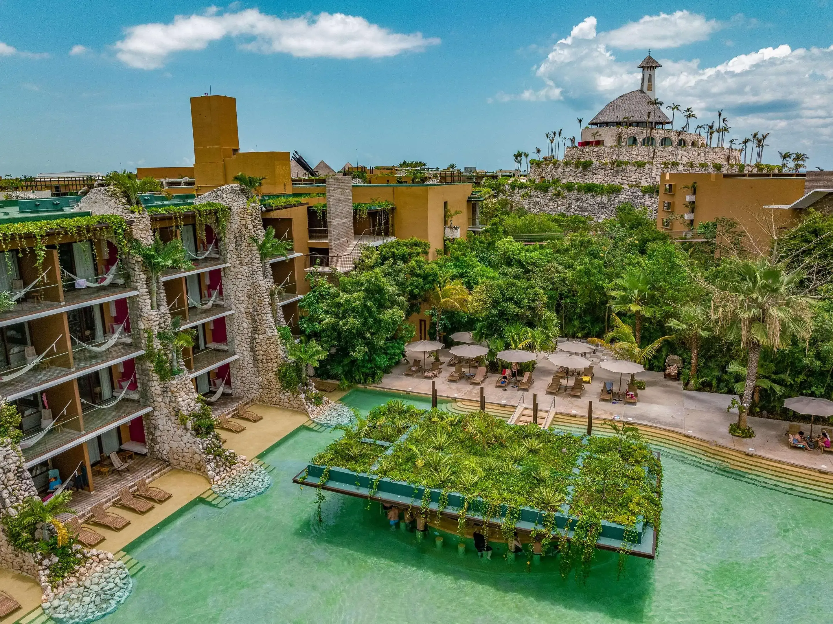 High angle view of a hotel complex with a pool in a tropical setting