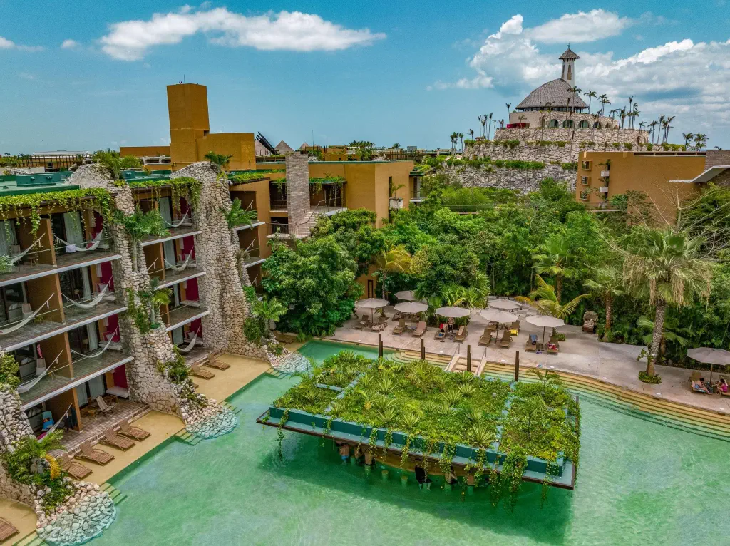 High angle view of a hotel complex with a pool in a tropical setting
