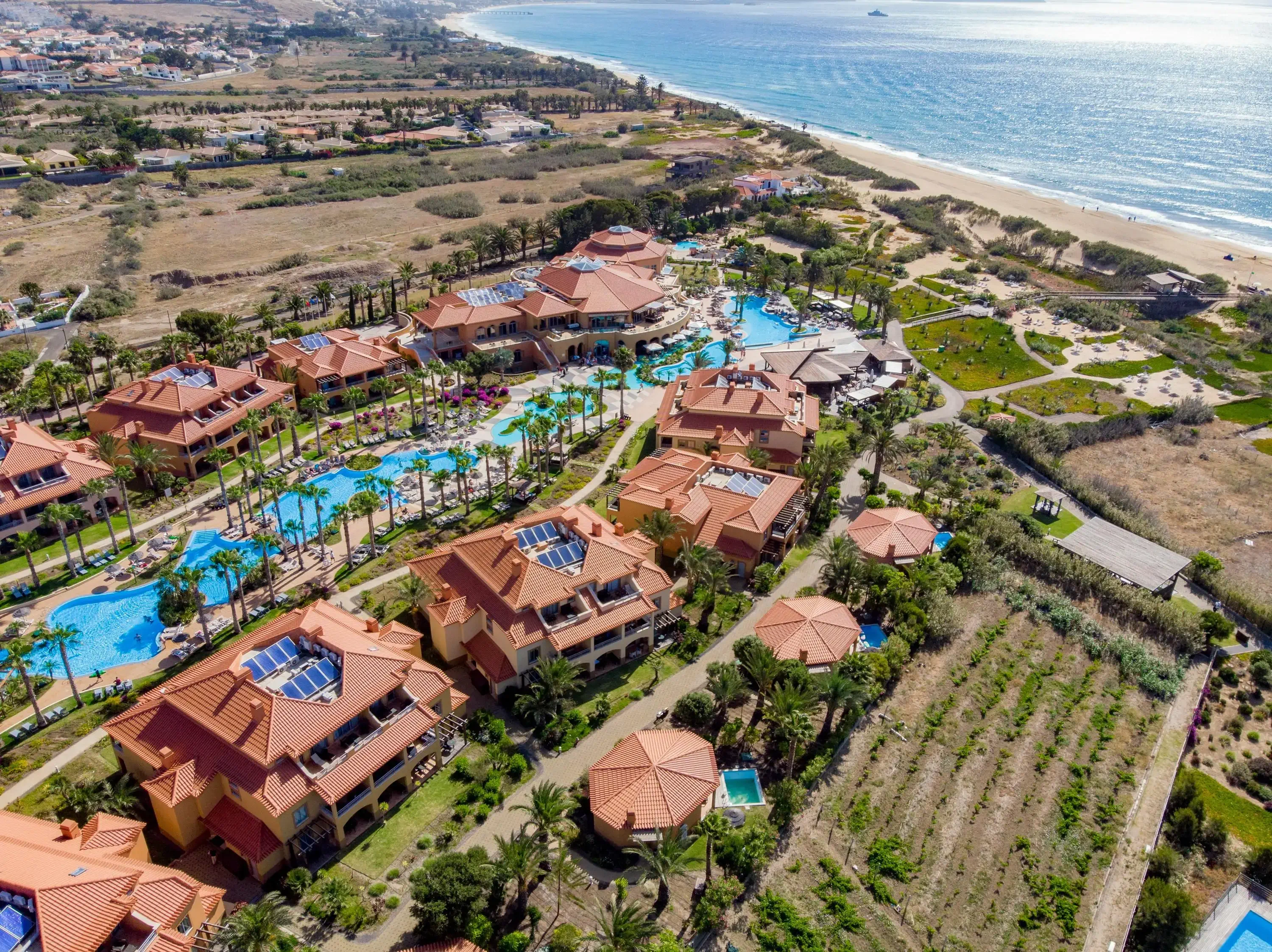 Aerial view of a beach resort with pool running through