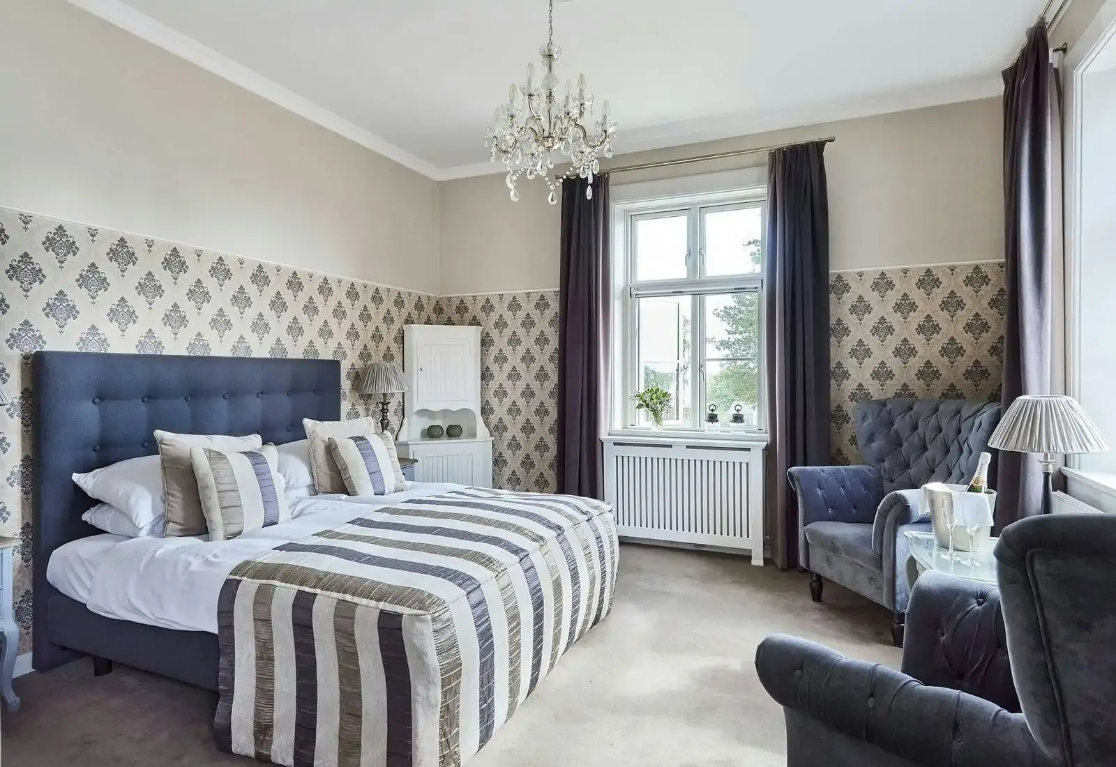 Cozy modern classic hotel room in purple shade soft furnishings